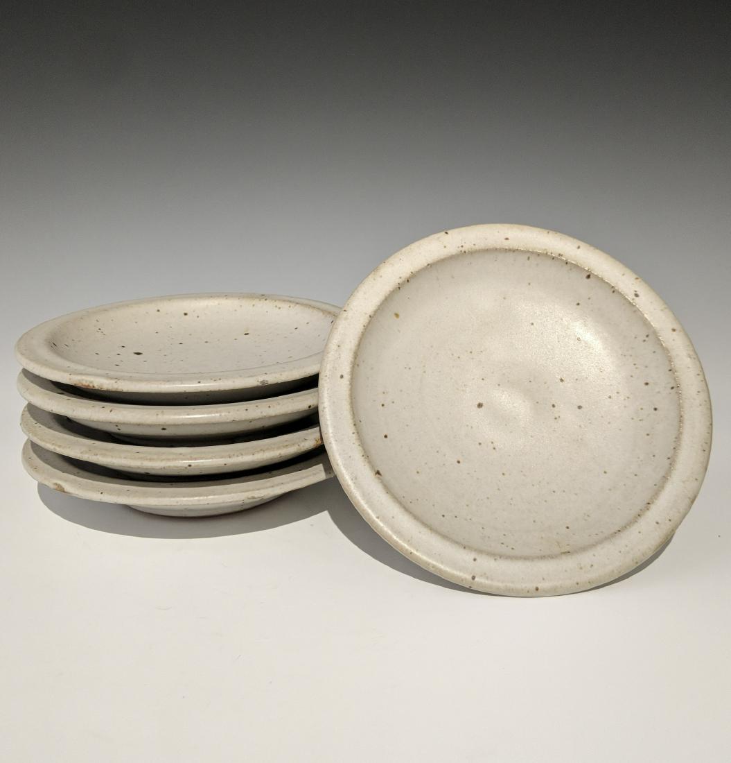 Warren MacKenzie - Five small plates: Lot 122 Warren MacKenzie - Five small plates American (1924-2018) Five small plates stoneware with white glaze MacKenzie stamps on feet 6 1/4 x 1 1/2 inches each Provenance: from the Collection of Art