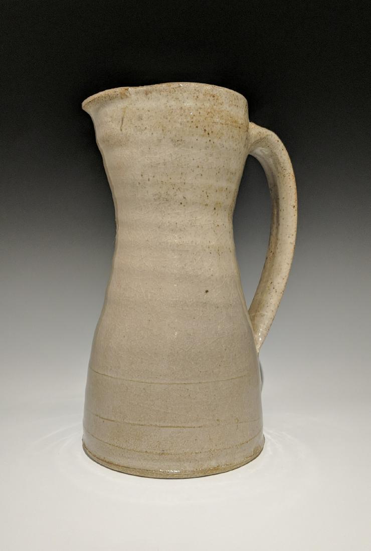 Warren MacKenzie - Tall pitcher: Lot 148 Warren MacKenzie - Tall pitcher American (1924-2018) Tall pitcher stoneware with shino glaze MacKenzie and Stillwater stamps on foot 11 x 6 inches Provenance: from the Collection of Arthur &
