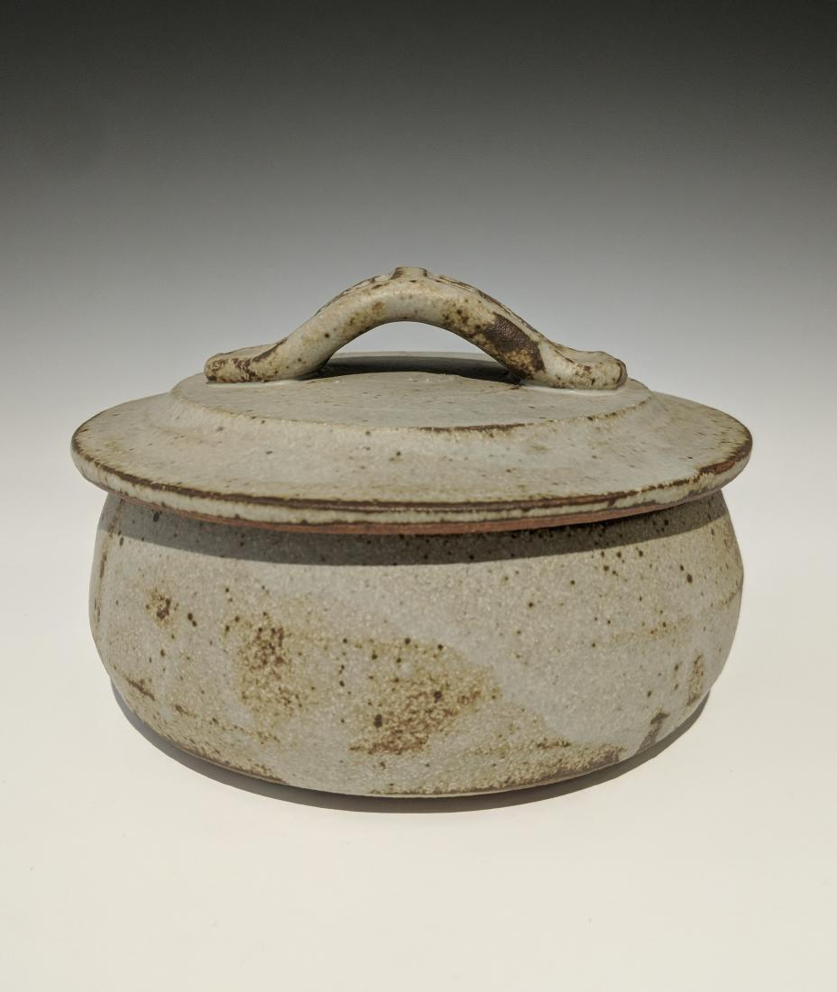 Warren MacKenzie - Covered dish with paddled handle: Lot 149 Warren MacKenzie - Covered dish with paddled handle American (1924-2018) Covered dish with paddled handle stoneware with matte glaze MacKenzie stamp on foot Body: 2 1/2 x 5 inches cap: 2 3/4 x