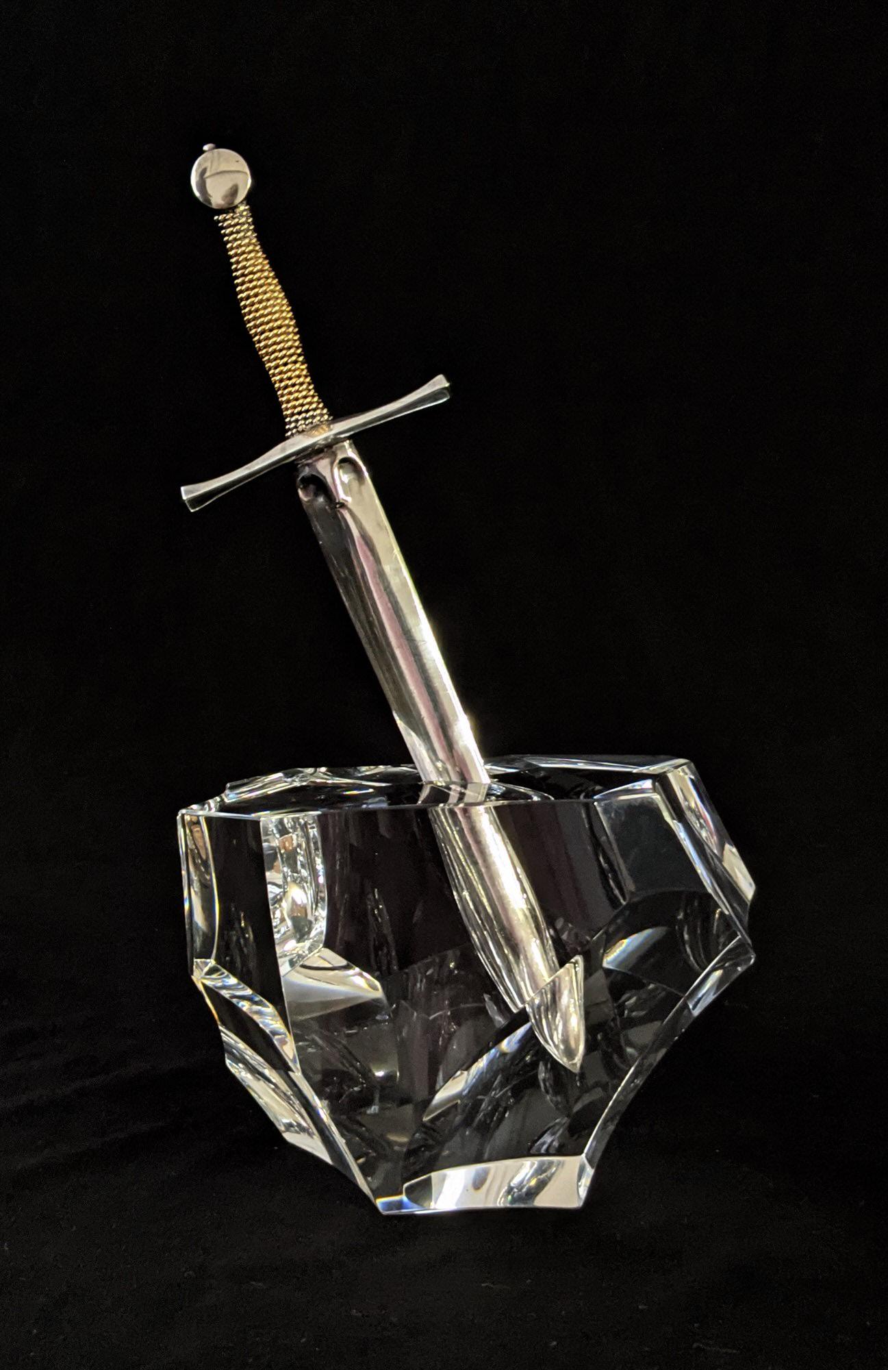 James Houston for Steuben Glass - Excalibur:: Lot 2 James Houston for Steuben Glass Excalibur: paperweight and letter opener (1963) crystal paperweight and silver with gold handle letter opener inscribed on the base height: 8 inches width: 4 3/4