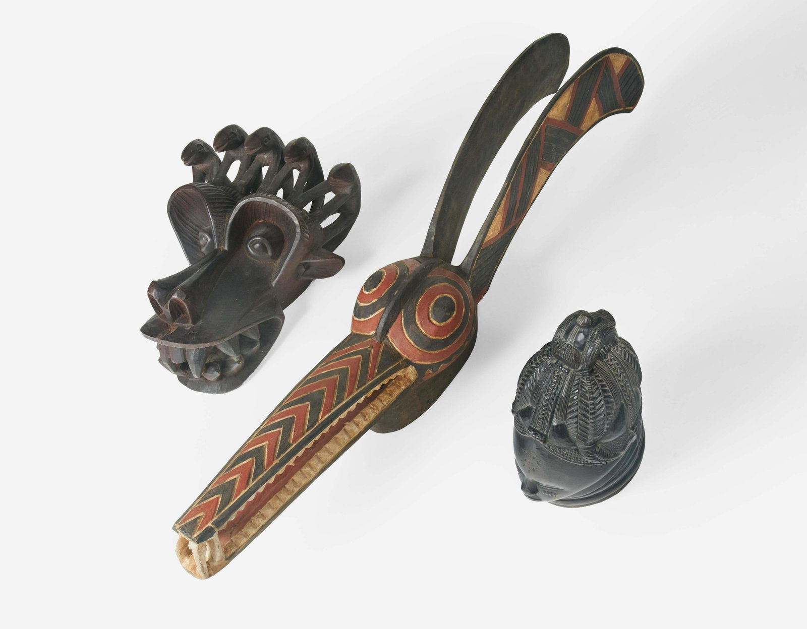 African - Lot of 3 Decorative Masks: Lot 89 African Lot of 3 Decorative Masks (20th Century) painted wood largest: 56 x 9 inches