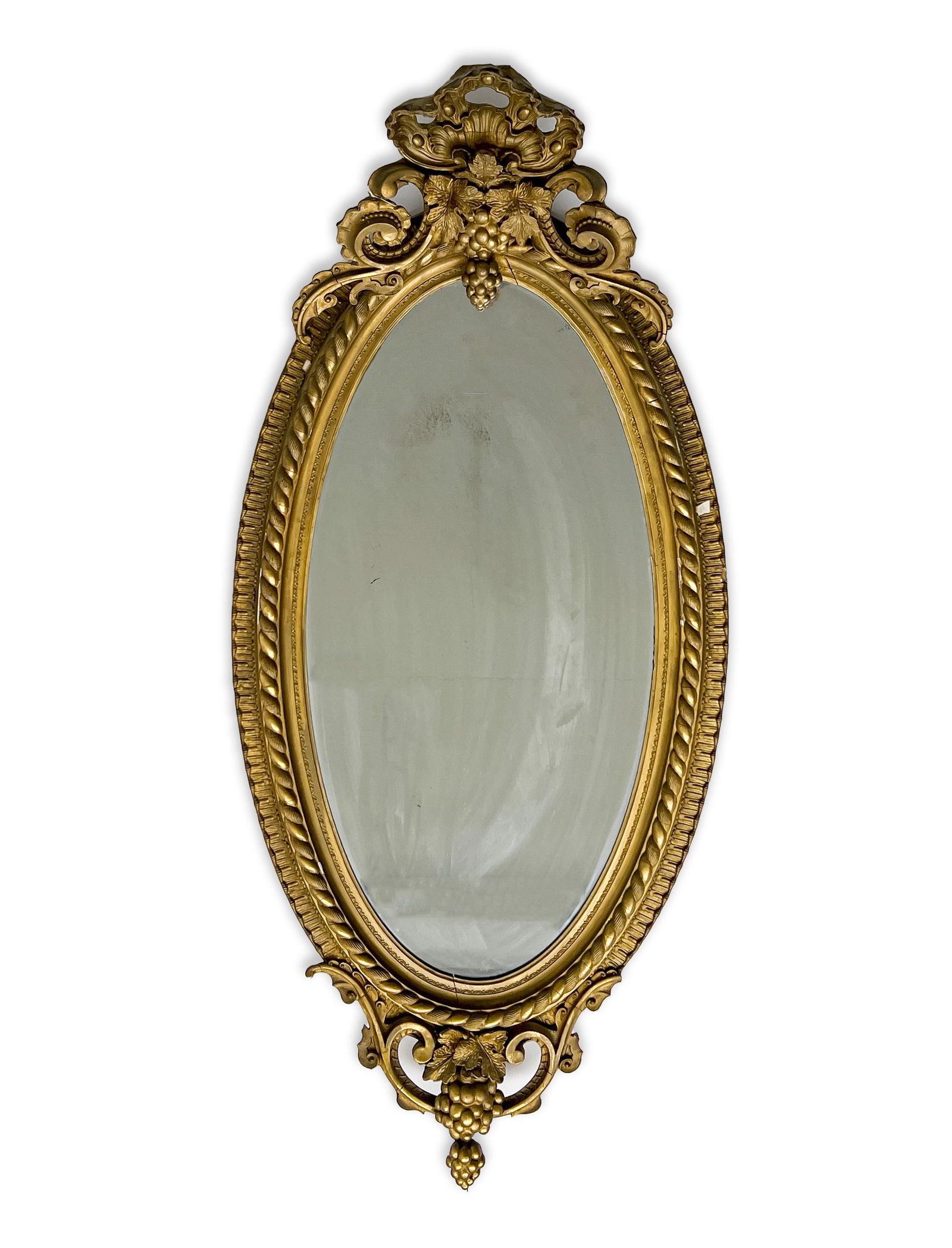Large Oval Giltwood Mirror: Lot 143 Large Oval Giltwood Mirror having grape and palmette motifs with scrolling to crest, twisted rope motif surround, and grape and scrolling motif to base 60 x 28 x 11 inches Provenance: Dr. Wil