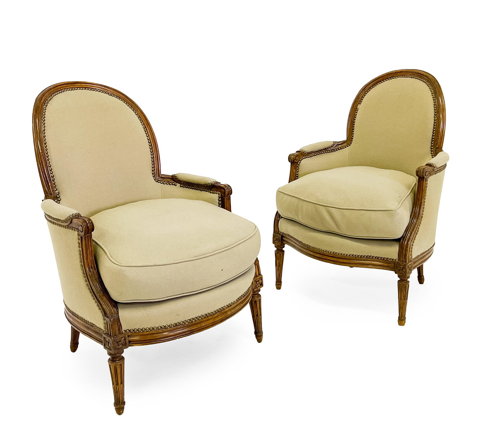 Pair of Louis XV Chevigny Stamped Bergères: Lot 196 Pair of Louis XV Chevigny Stamped Bergères (late 18th century) each with arched back and nailhead-trimmed upholstery, the frame with rosette details and raised on tapered fluted legs, und
