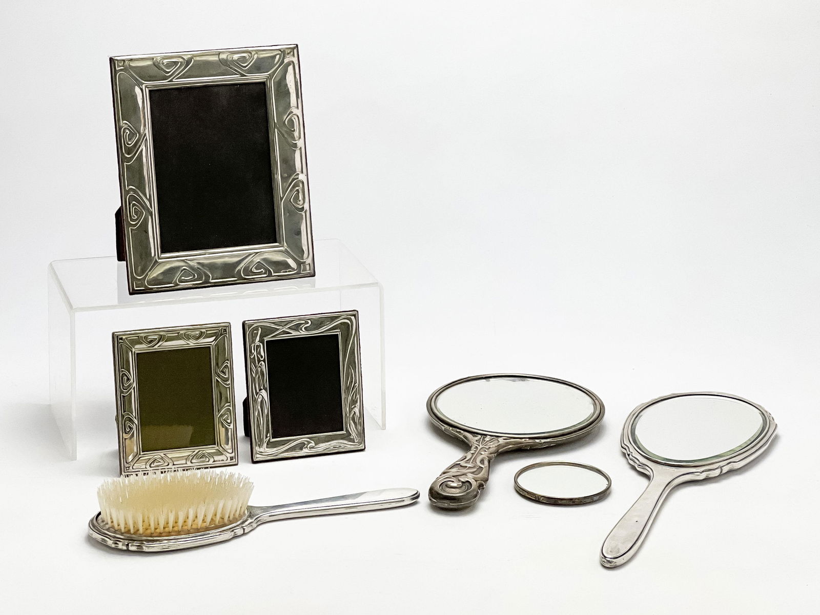 Silver Accessories, Group of 7: Lot 176 Silver Accessories, Group of 7 this lot includes 3 sterling picture frames of various sizes, each with 925 hallmark, 1 hairbrush, marked sterling, two hand mirrors, one marked sterling and on