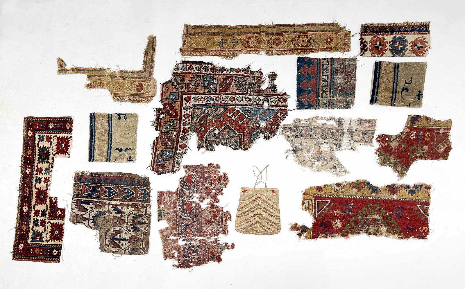 14 fragments: Lot 172 14 fragments including one shoulder bag and two pillow shams larger sham: 13 x 14 inches smaller sham: 12 x 12 1/4 inches Provenance: Jim Dixon Collection