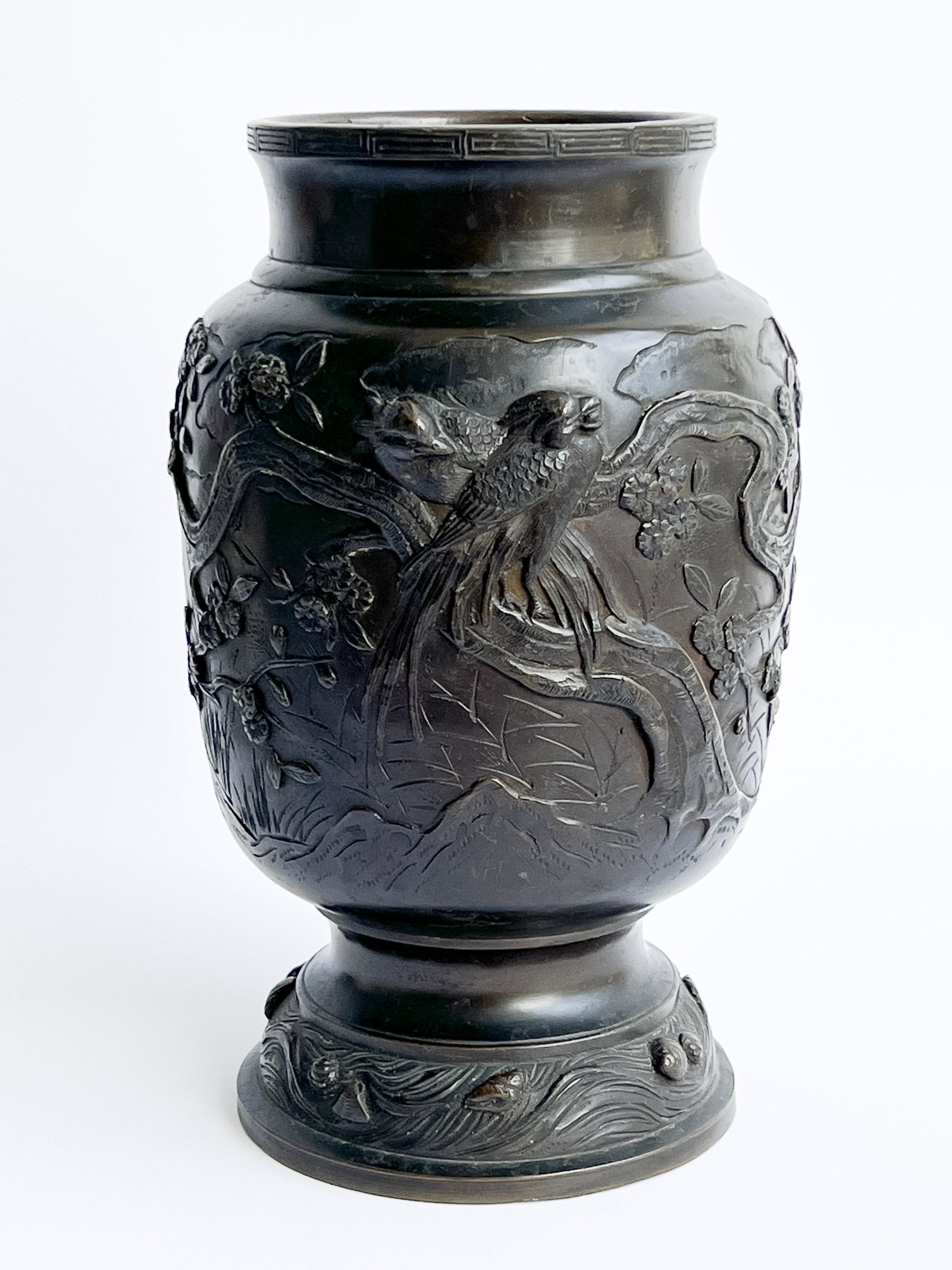 Japanese Bronze Urn: Lot 67 Japanese Bronze Urn with relief depicting birds amongst blossoming trees, and with stamp to base height: 11 3/4 inches diameter: 6 1/2 inches Provenance: From the Estate of Robert Schiffman