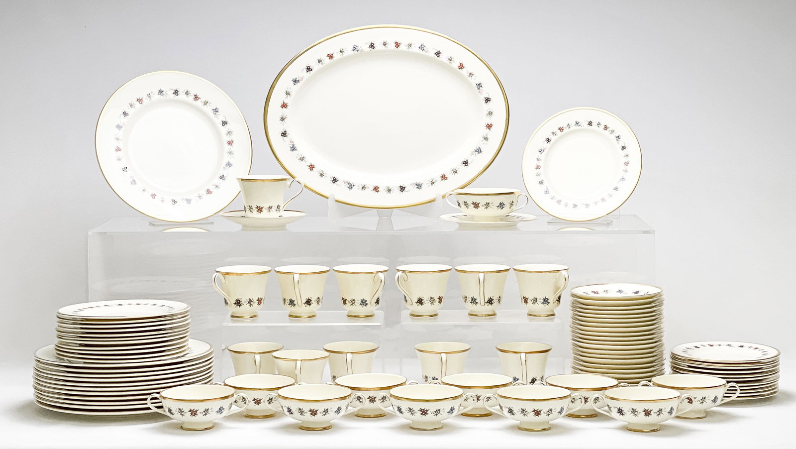 Minton Mirabeau Bone China (83 pieces) Partial Service: Lot 55 Minton Mirabeau Bone China (83 pieces) Partial Service 83 total pieces, including 1 serving platter 11 cream soup bowls with saucers 12 teacups with saucers 12 dessert plates 12 dinner plates 1