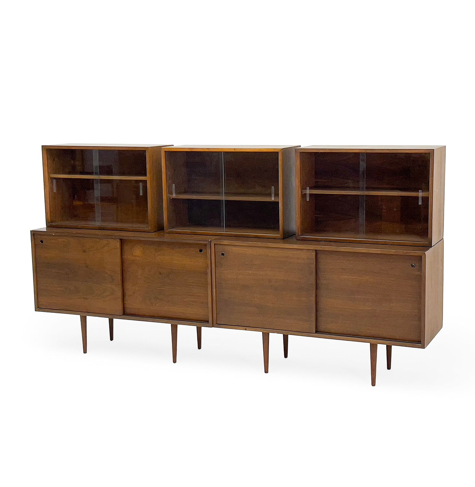 Mel Smilow - Modern Credenzas with Cabinets: Lot 165 Mel Smilow American (1922-2002) Modern Credenzas with Cabinets walnut comprised of two credenzas with sliding doors, with one shelf in each door, accompanied by 3 stackable wooden cabinets wit
