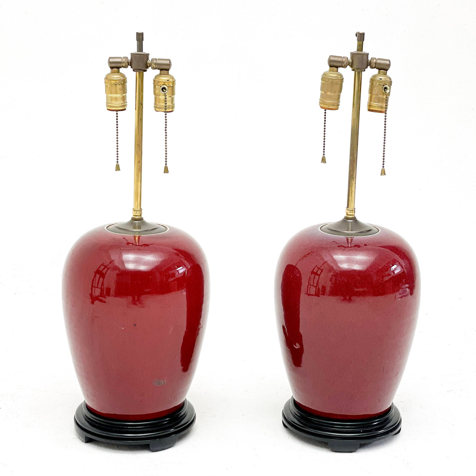 Chinese Sang de Bouef Porcelain Lamps, Pair: Lot 132 Chinese Sang de Bouef Porcelain Lamps, Pair of ovoid form, mounted on a turned lacquer base, each with double socket and red gingham shade height (each): 29 inches Provenance: From a 956 5th A
