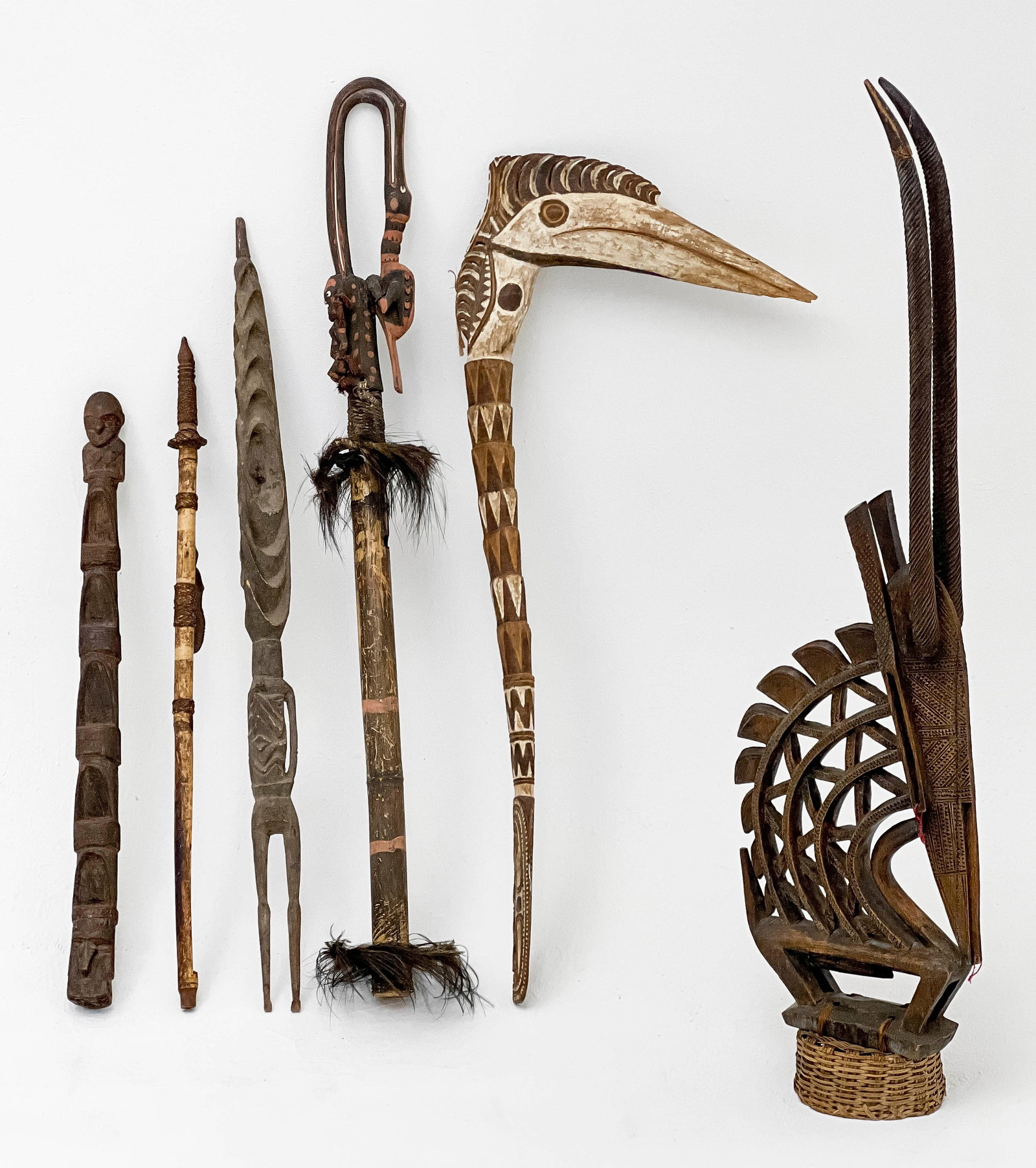 Aboriginal and African Staffs and Statue, Group of 6: Lot 223 Aboriginal and African Staffs and Statue, Group of 6 made from wood, woven materials, and feathers lot includes one metal stand largest: 49 1/2 x 6 x 6 inches Provenance: From an Upper West Si