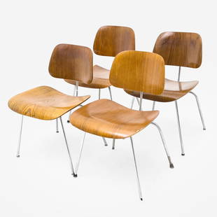 Charles and Ray Eames - DCM Dining Chairs, Group of 4: Lot 111 Charles and Ray Eames American (20th Century) DCM Dining Chairs, Group of 4 for Herman Miller plywood dining chairs with walnut veneer and chrome base each: 29 x 19 x 19 inches seat height: 18