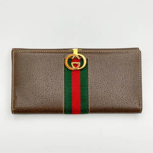 Gucci - Leather Wallet: Lot 10 Gucci Italian Manufacturer (Founded 1921) Leather Wallet single fold leather wallet with Gucci logo clasp marked Gucci to interior 3 1/2 x 7 inches Provenance: From a Private New York