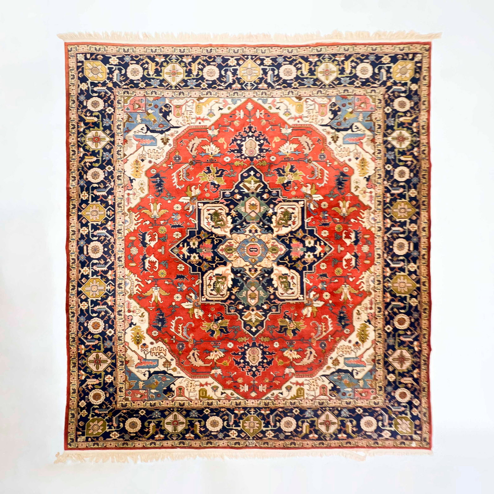 Isphahan Rug ,: Lot 47 Isphahan Rug , red ground with dark blue and ivory medallion and border, featuring floral motifs, with sewn on fringe 12 ft 1/2 in x 9 ft 10 in Provenance: The Estate of Eveline Hunt