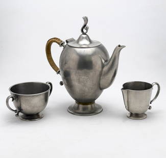 Edvin Ollers - Three-Piece Tea Set: Lot 55 Edvin Ollers Swedish (1888-1959) Three-Piece Tea Set pewter for Gjutet Tenn, comprising teapot, creamer, and sugar bowl marked to undersides teapot: 8 1/2 x 8 x 4 inches Provenance: From a