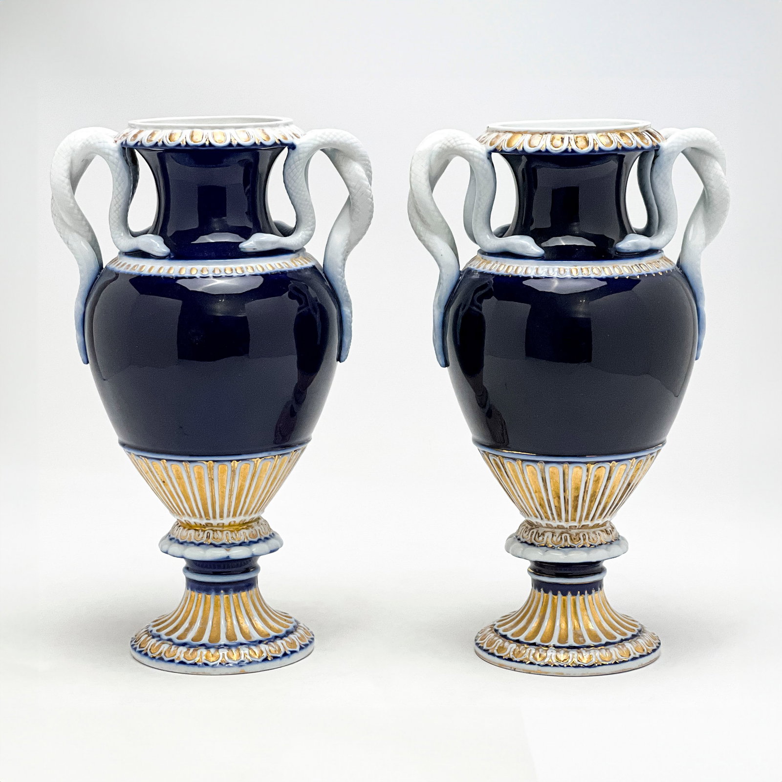 Meissen - Cobalt Blue Serpent Porcelain Vases, Pair: Lot 92 Meissen German Manufacturer (Founded 1710) Cobalt Blue Serpent Porcelain Vases, Pair porcelain baluster shape, socle base, figurative snake handles, cobalt blue with gilt accents, and cross swo