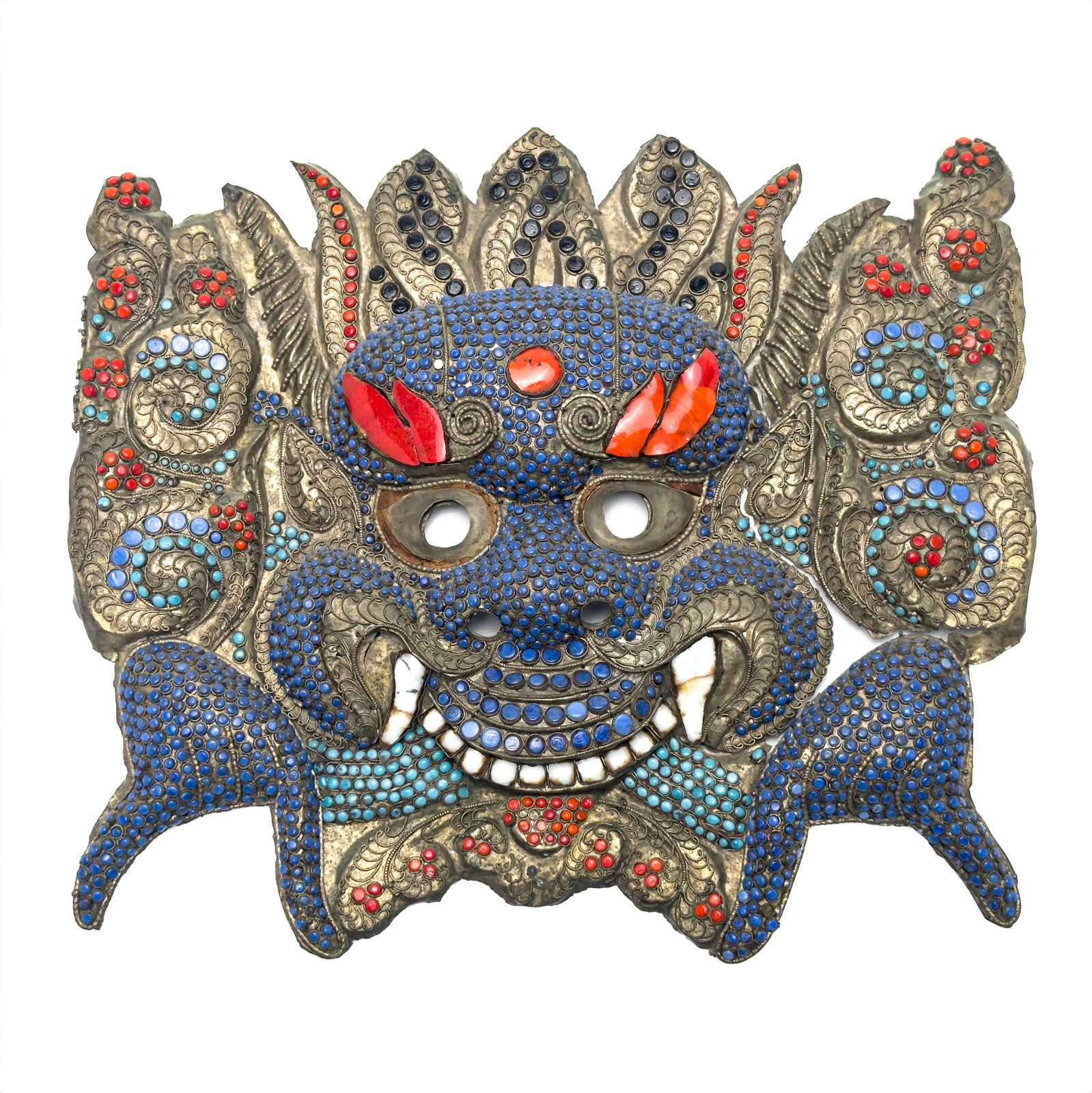 Asian - Kirtimukha Mask: Lot 140 Asian Kirtimukha Mask tin with glass Kirtimukha mask in brass with glass/enamel inlay in blue and red 13 x 14 1/2 inches Provenance: From an Upper West Side Collection