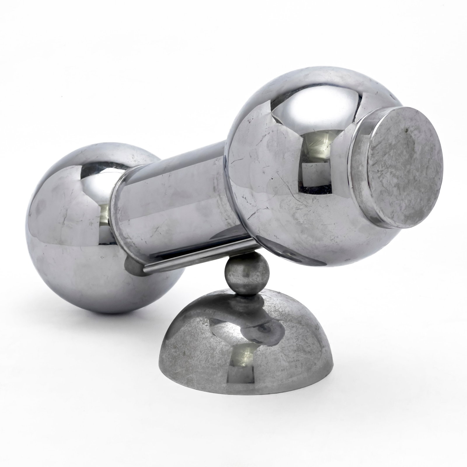 Art Deco Dumbbell Cocktail Shaker: Lot 262 Art Deco Dumbbell Cocktail Shaker chromed metal Comprising Art Deco dumbbell cocktail shaker with with cap, strainer, and stand with stand: 7 x 10 1/2 x 4 inches Provenance: The Estate of Ilon
