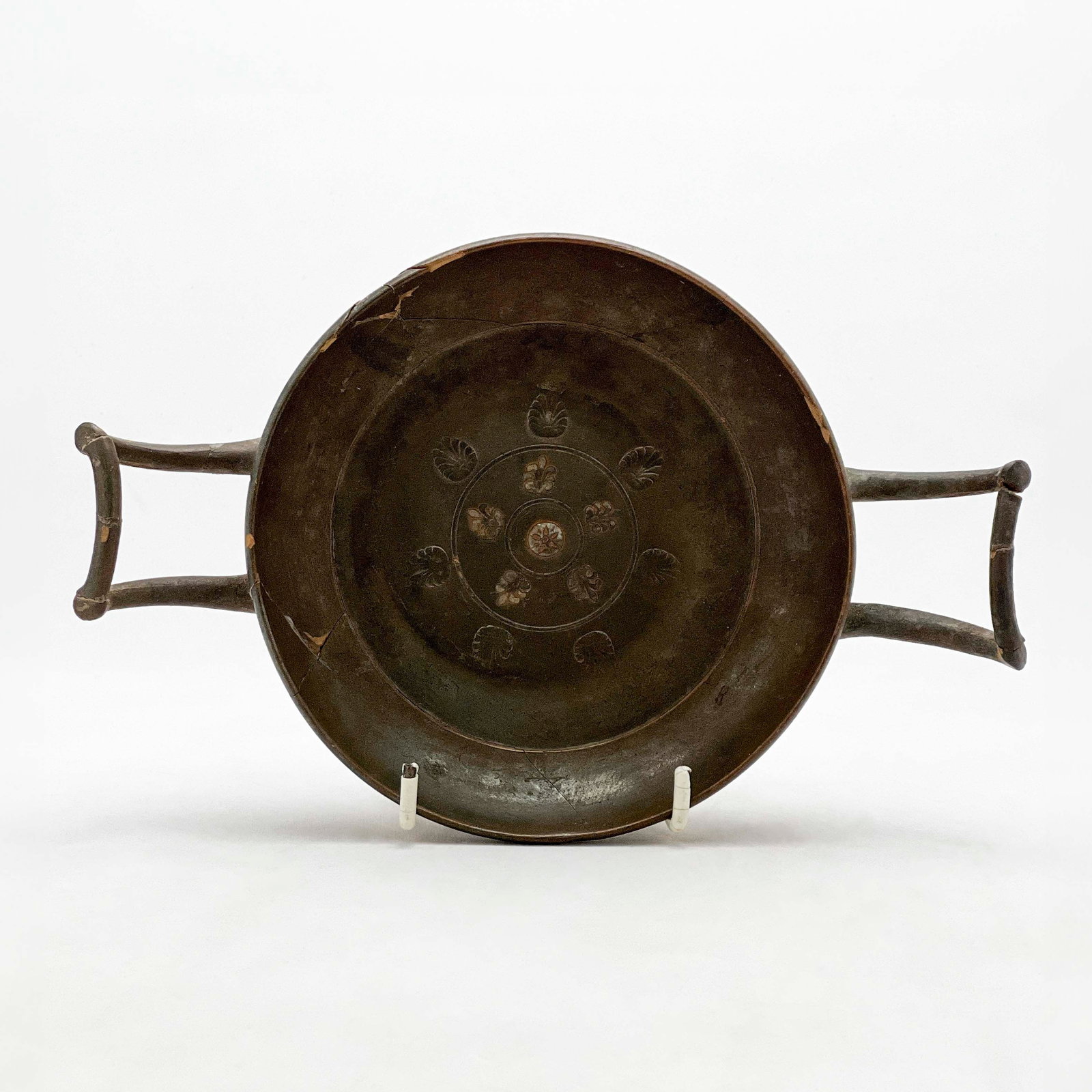 Stemless Kylix: Lot 36 Stemless Kylix blackware terracotta With two D shaped handles, decorated with palmette design 1 1/2 x 8 3/4 x 5 1//2 inches Provenance: From a Private New York Collection