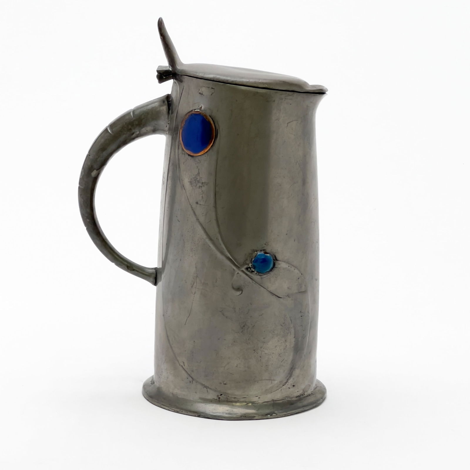 Archibald Knox - Tudric Jug for Liberty & Co.: Lot 72 Archibald Knox British (1864-1933) Tudric Jug for Liberty & Co. pewter, enamel manufacturer's stamp to bottom height: 8 1/4 inches diameter: 4 inches Provenance: property from a Brooklyn Height