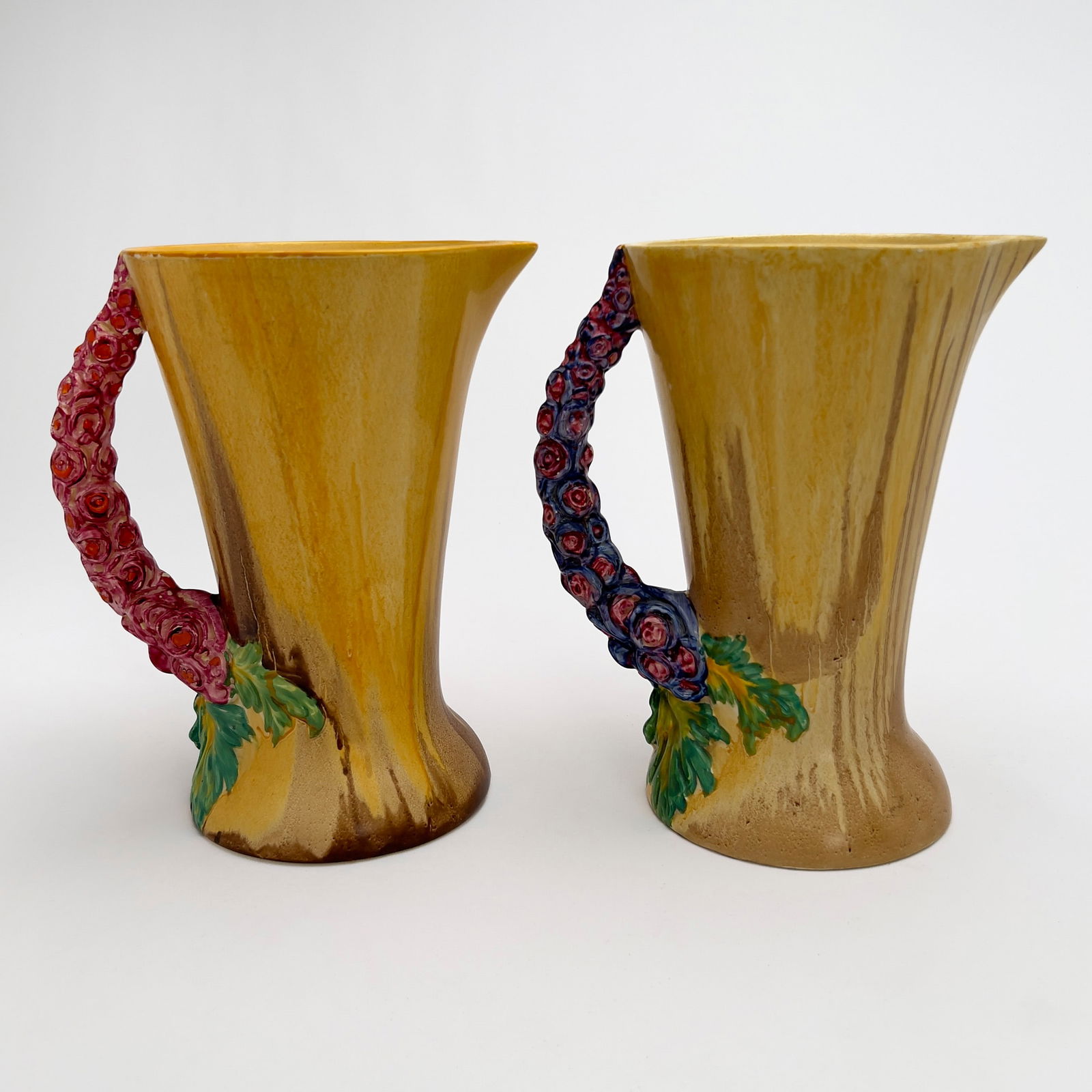 Clarice Cliff - Pair of Bizarre Pitchers in ”My Garden”: Lot 75 Clarice Cliff English (1899-1972) Pair of Bizarre Pitchers in ”My Garden” hand-painted ceramic Two Bizarre ceramic pitchers in the pattern ”My Garden” with pink and blue