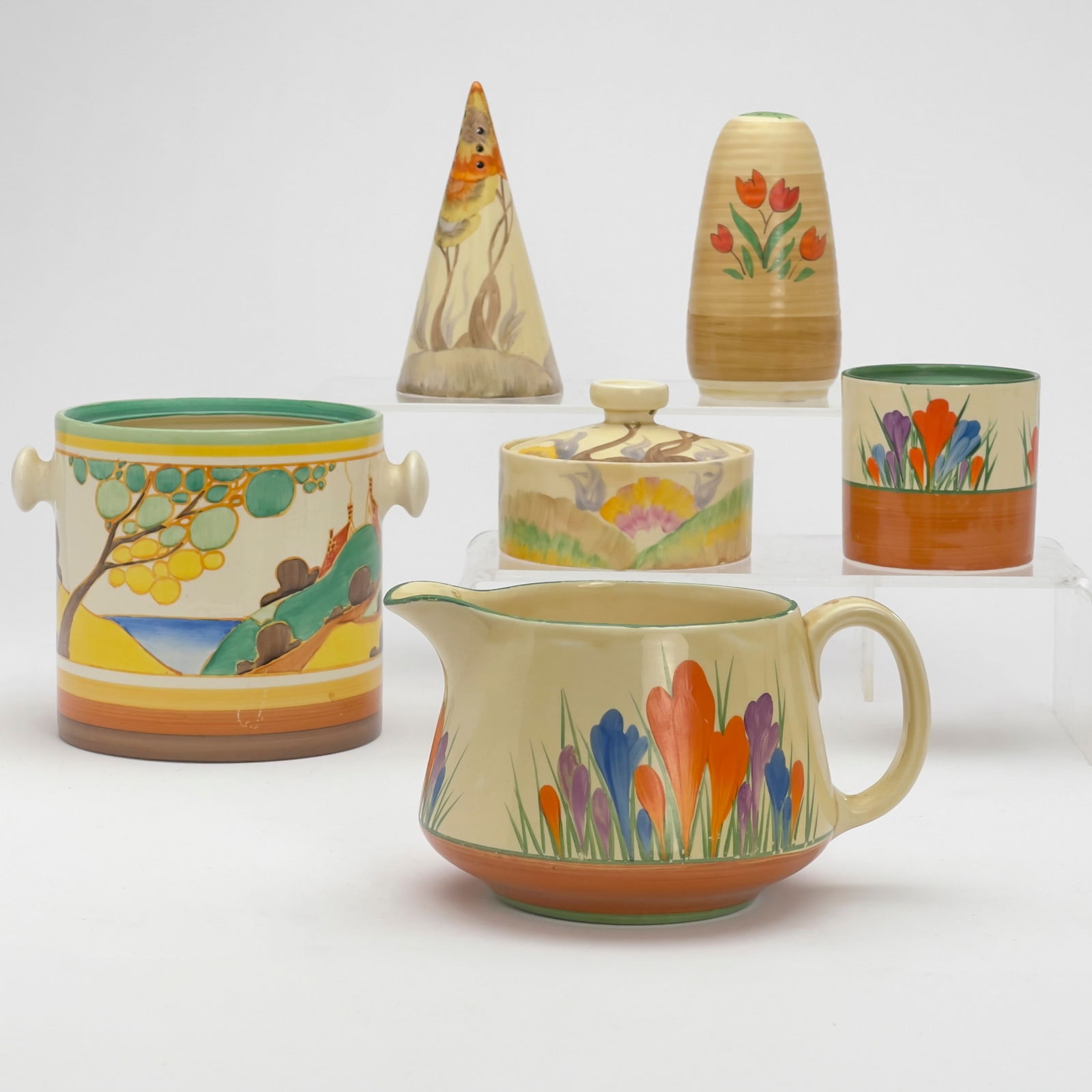 Clarice Cliff - Bizarre Ceramic Dishes in Various Patterns, Group of 6: Lot 83 Clarice Cliff English (1899-1972) Bizarre Ceramic Dishes in Various Patterns, Group of 6 hand-painted ceramic Comprising of a pitcher and cup in ”Crocus,” a conical shaker and small