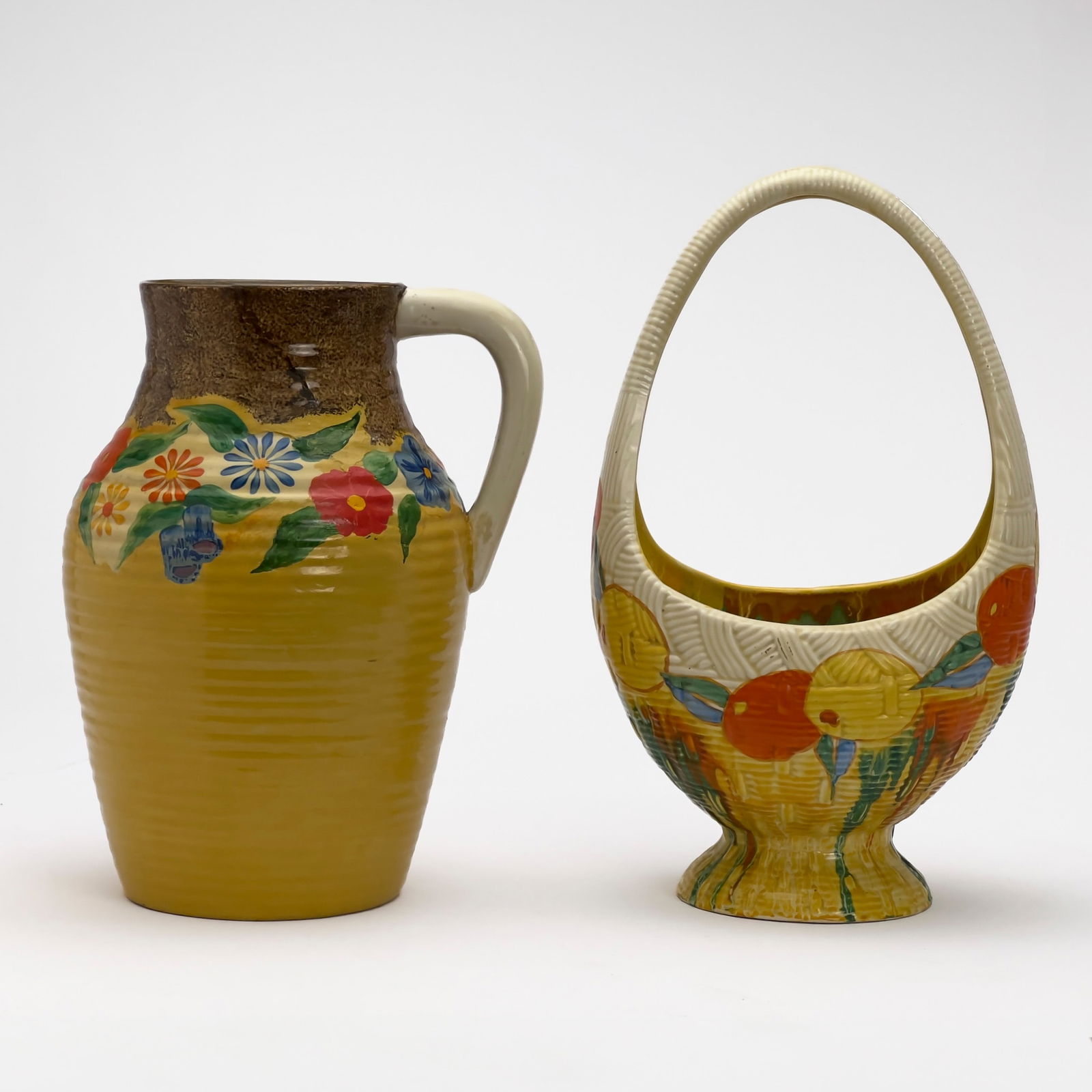 Clarice Cliff - Bizarre Isis Vase and Gaiety Basket: Lot 86 Clarice Cliff English (1899-1972) Bizarre Isis Vase and Gaiety Basket hand-painted ceramic Bizarre ceramic Isis vase in ”Canterbury Bells” and Gaiety basket in ”Delecia”