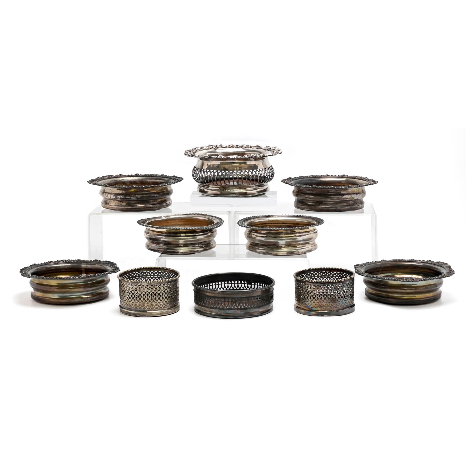 Silverplate Wine Coasters, Group of 10: Lot 145 Silverplate Wine Coasters, Group of 10 silverplate, wood Comprising ten silverplate and wood wine coaster, of varying sizes, several with pierced sides and decorated rims height (largest): 3