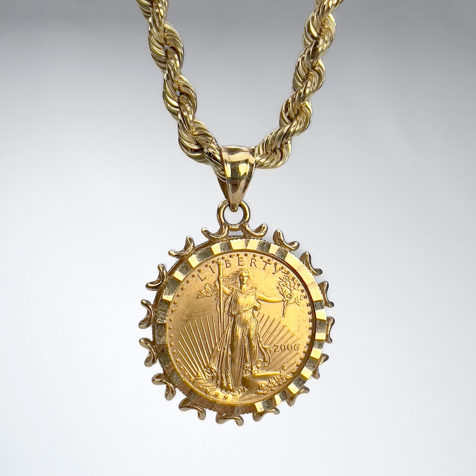 Gold 10 Dollar Walking Liberty Coin Pendant With Chain: Lot 36 Gold 10 Dollar Walking Liberty Coin Pendant With Chain 14k gold A 2006 10 Dollar Walking Liberty pendant in a 14k gold mount accompanied with a 14k gold chain approx total pendant weight: 11.5