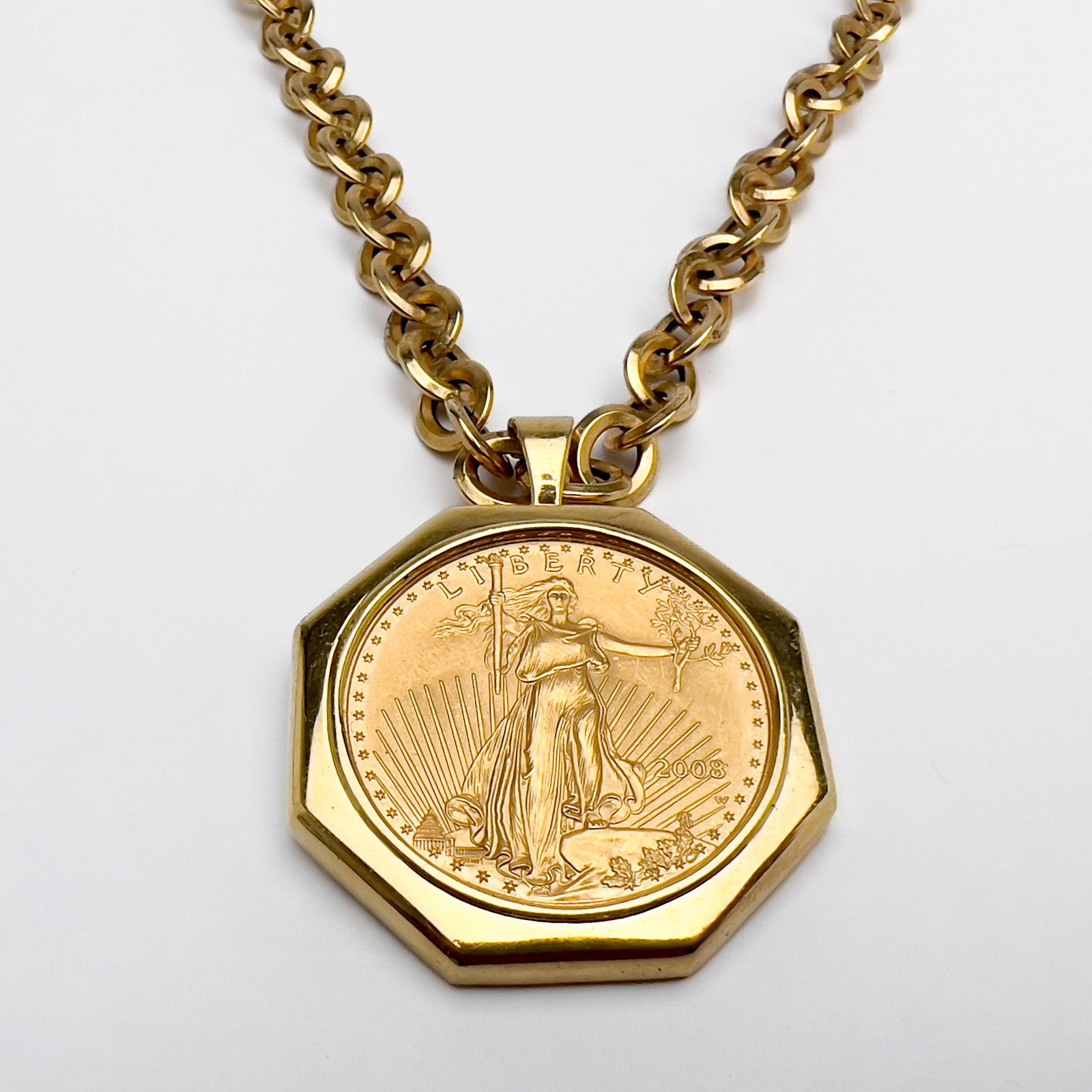 Gold 50 Dollar Walking Liberty Coin Pendant and Chain: Lot 38 Gold 50 Dollar Walking Liberty Coin Pendant and Chain 18k gold, 14k gold A 2008 50 Dollar Walking Liberty pendant in an 18k gold (tested) mount accompanied with a 14k gold Mylar chain approx t