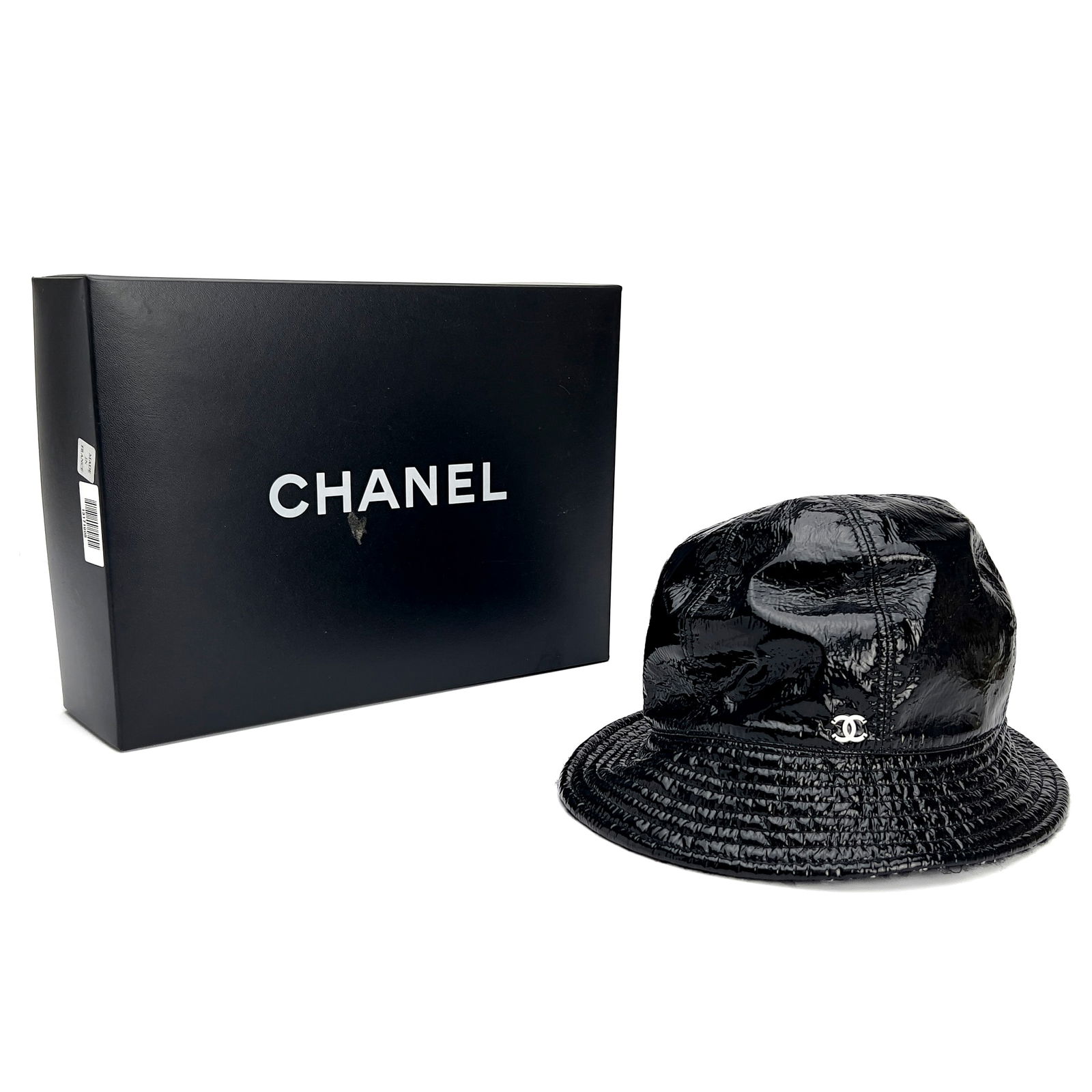 Chanel - Bucket Hat: Lot 85 Chanel French Manufacturer (Founded 1910) Bucket Hat polyester, wool, cotton Black Chanel bucket hat with logo at front and a wool, cotton tweed inner trim, designer size 58. With box with labe
