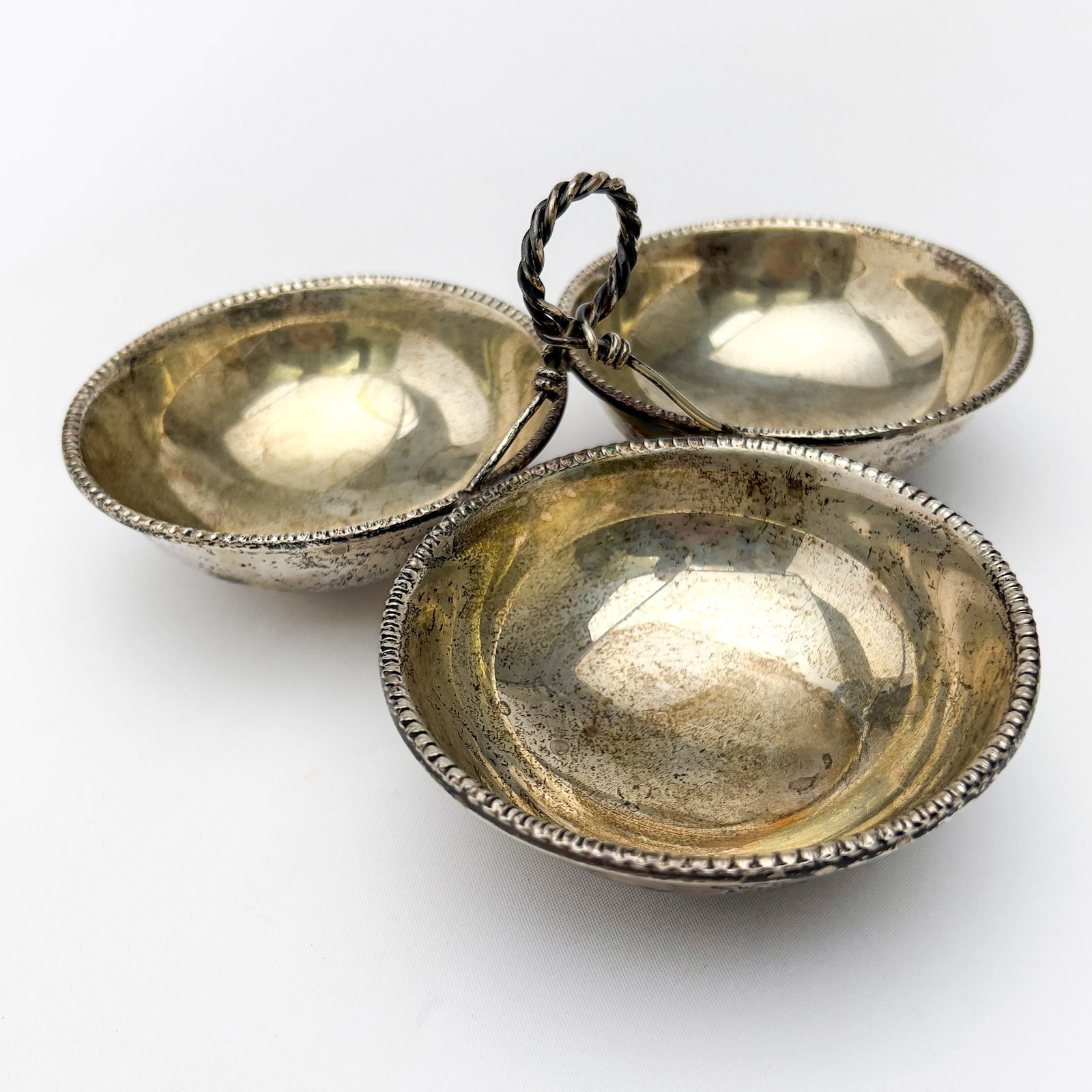 Silver Three Sectioned Nut Bowl: Lot 115 Silver Three Sectioned Nut Bowl sterling silver A sterling silver dish with raised handle above three interconnected bowls total approximate weight: 205 grams with marks 4 1/2 x 8 1/4 inches