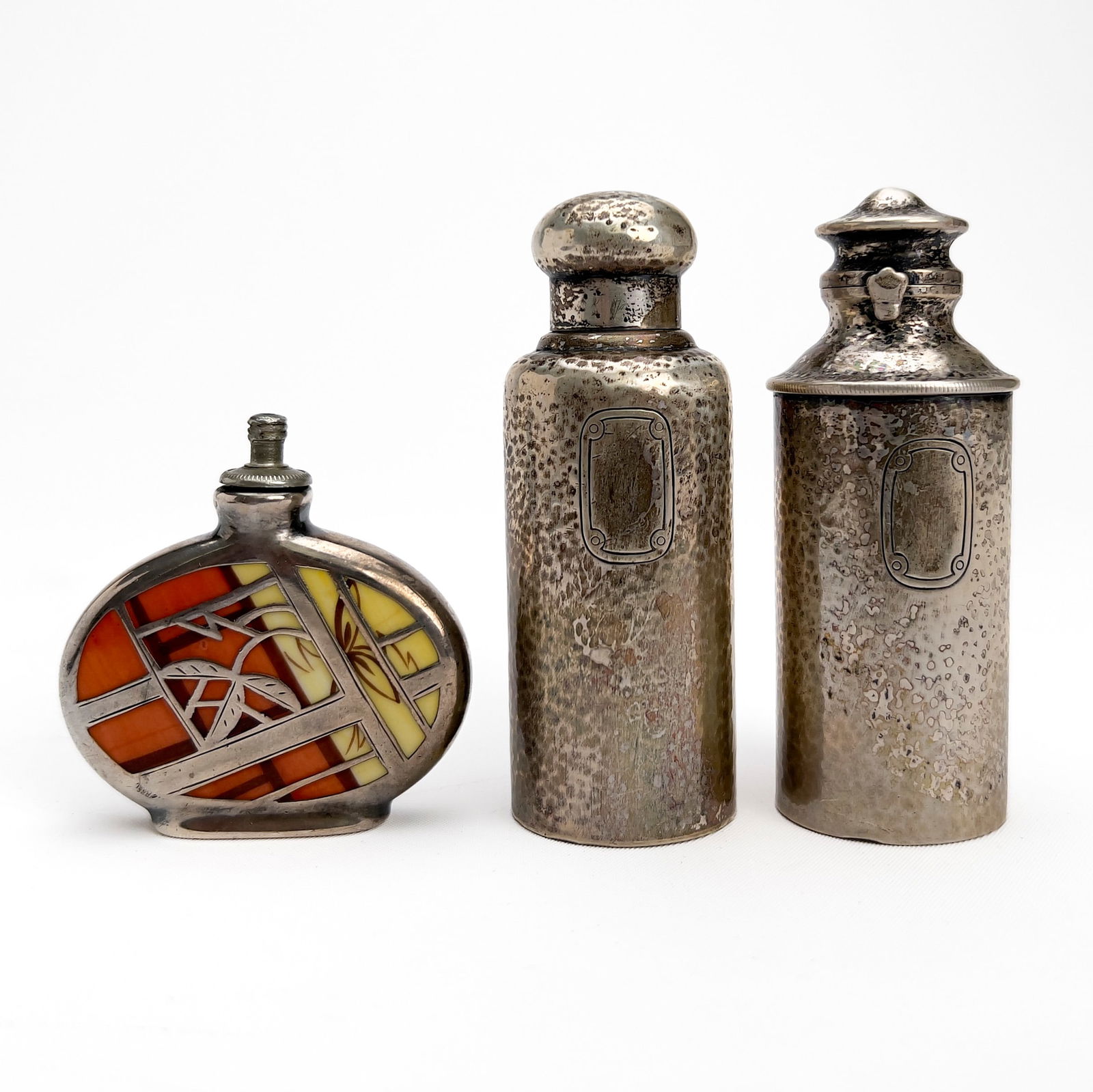 Tiffany & Co. - Two Hammered Silver Vanity Bottles along with a Spahr Style Perfume Bottle: Lot 118 Tiffany & Co. American Manufacturer (Founded 1837) Two Hammered Silver Vanity Bottles along with a Spahr Style Perfume Bottle sterling and porcelain Silver vanity items group, tiffany bottles