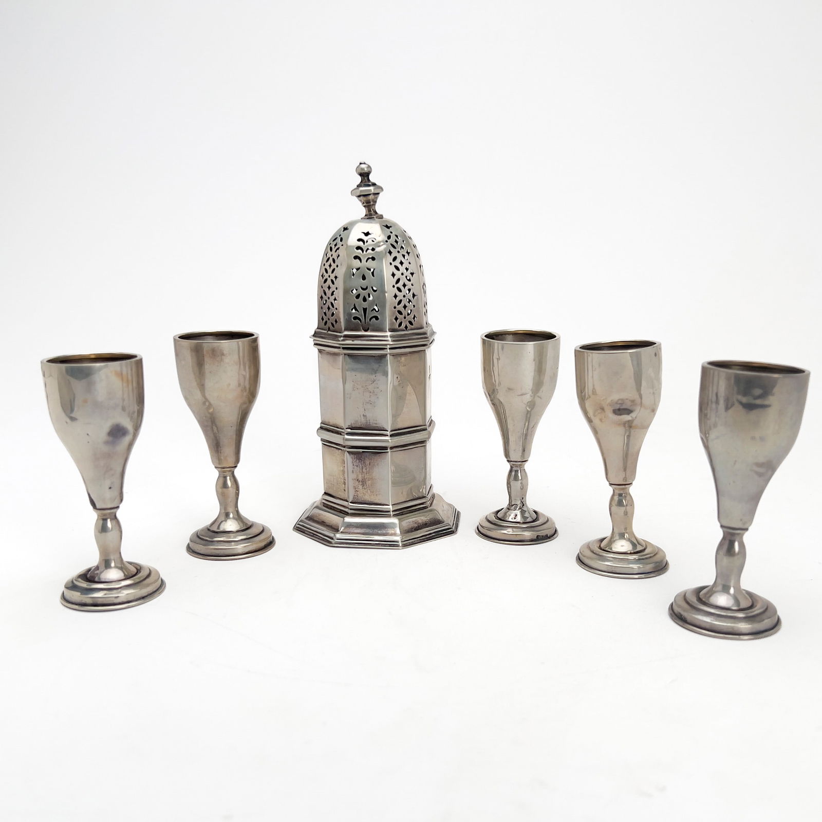 Silver Sugar Caster and Cordials: Lot 129 Silver Sugar Caster and Cordials sterling silver Comprising one large Victorian sterling sugar caster by George Nathan & Ridley Hayes and five small cordials total approximate weight: 216 gra