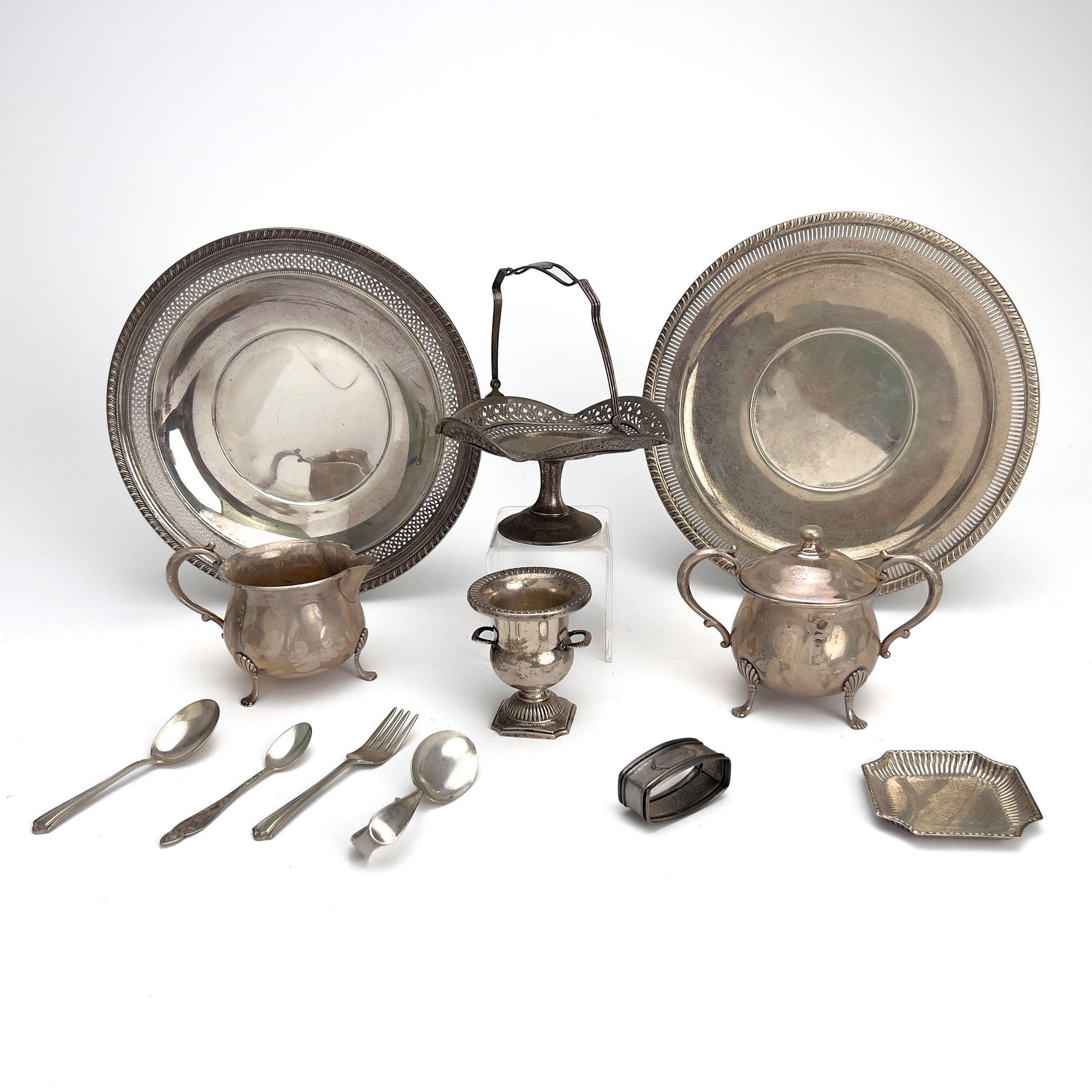 Silver Tableware Accessories, Group of 12: Lot 162 Silver Tableware Accessories, Group of 12 sterling silver Sterling silver group, comprising of two serving trays, a sugar bowl and cream jug marked Empire, a cake basket marked GHF, a