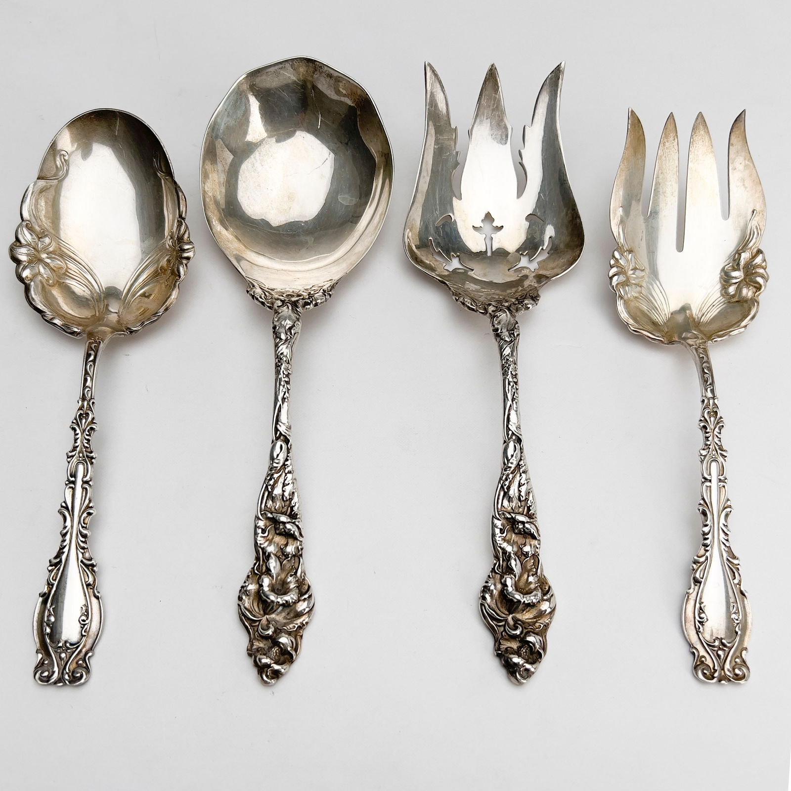 Four Ornate Large Silver Serving Pieces: Lot 173 Four Ornate Large Silver Serving Pieces sterling silver Sterling silver group, comprising of two sets of sterling serving pieces total approximate weight: 470 grams each marked length: 9 1/2