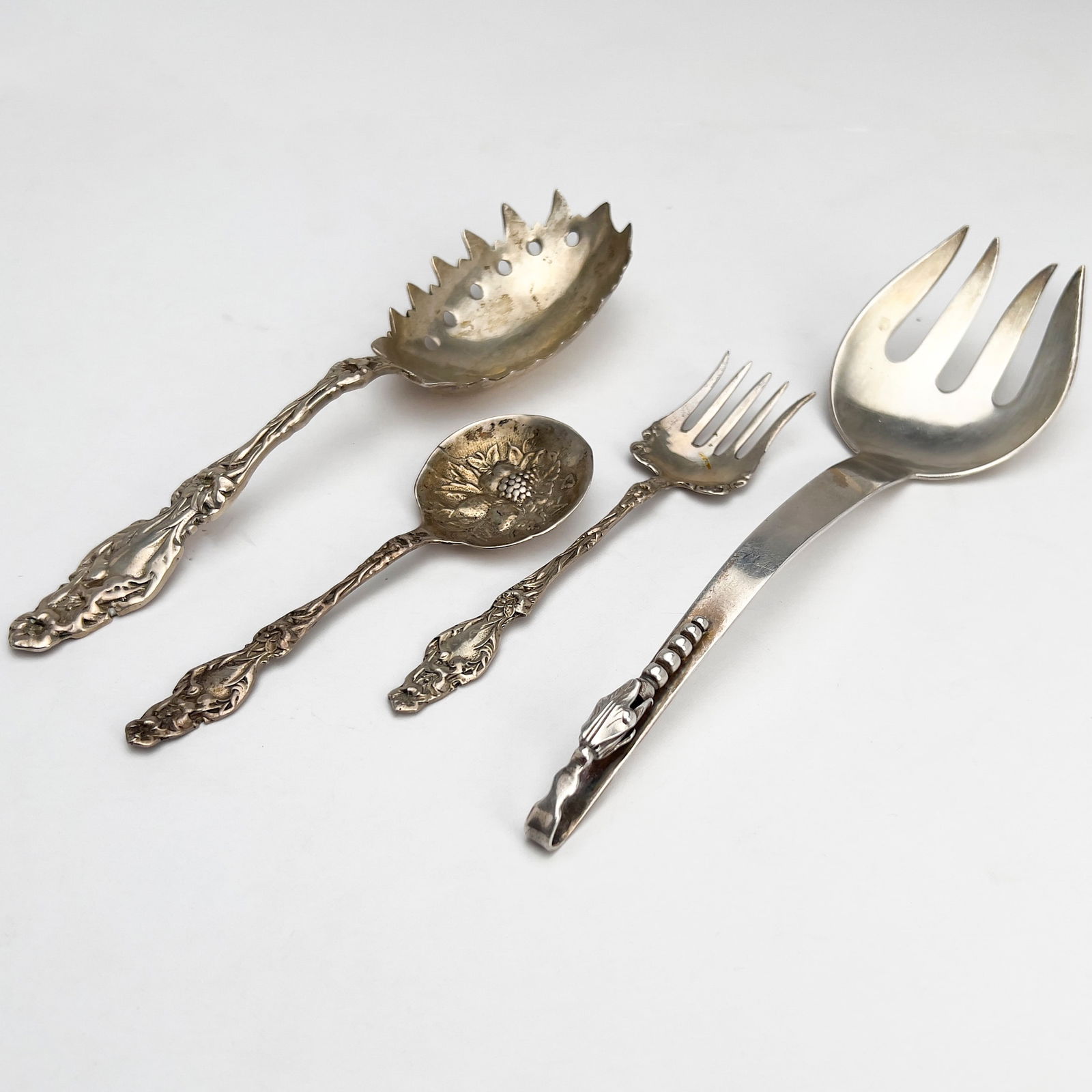 Silver Serving Pieces, Group of 4: Lot 174 Silver Serving Pieces, Group of 4 sterling silver Sterling silver group, comprising of a large serving fork and spoon, and a smaller decorated fork and spoon total approximate weight: 309