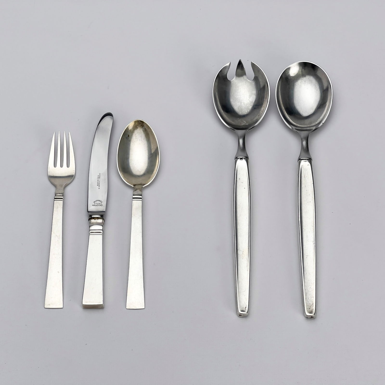 Georg Jensen Silversmithy - Silver Children's Set and Salad Servers: Lot 178 Georg Jensen Silversmithy Danish (20th Century) Silver Children's Set and Salad Servers sterling, stainless steel with Hallmarks salad spoon: 8 1/4 inches Provenance: From a Private Collection