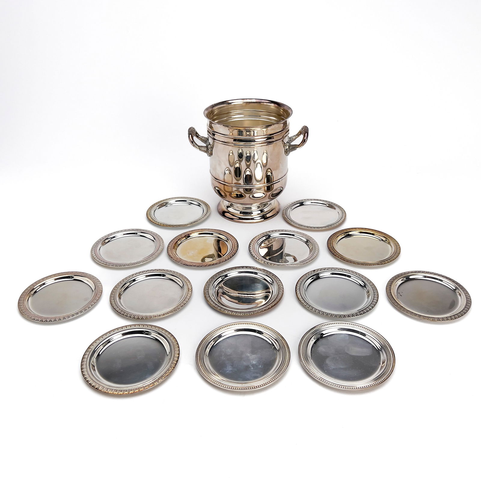 Cristofle - Silverplate Champagne Cooler and Malmaison coasters: Lot 192 Cristofle French (Founded 1830) Silverplate Champagne Cooler and Malmaison coasters Christofle silverplate beverage group includes a two handled champagne/wine cooler, along with 12