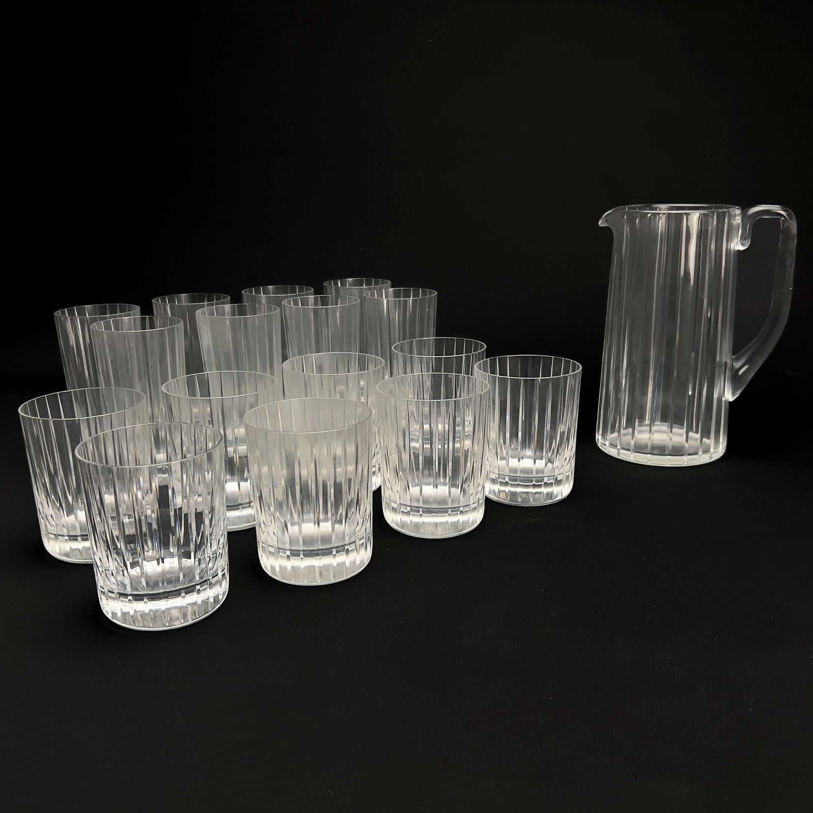 Baccarat - Harmonie Barware, Set of 17: Lot 202 Baccarat French Manufacturer (est. 1764) Harmonie Barware, Set of 17 crystal Comprising eight lowball tumbler glasses, eight highball tumbler glasses, and a pitcher all in the harmonie pattern