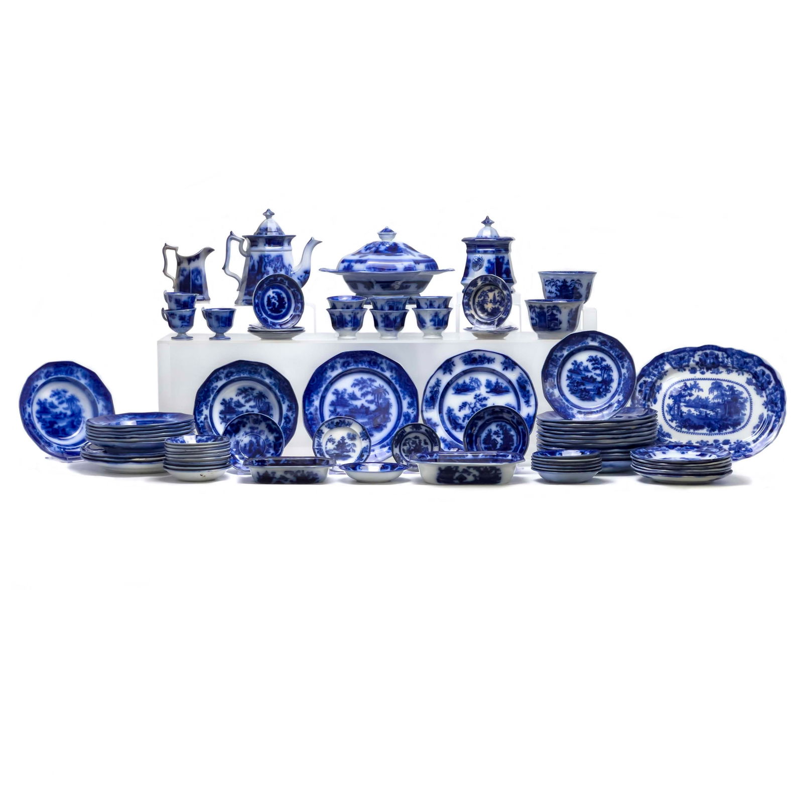 Flow Blue Serviceware, Group of 70+: Lot 212 Flow Blue Serviceware, Group of 70+ ironstone Large Flow Blue group, comprising of plates/dishes ranging from small plates to large platters, tureens, teapot, creamer, and various cups among