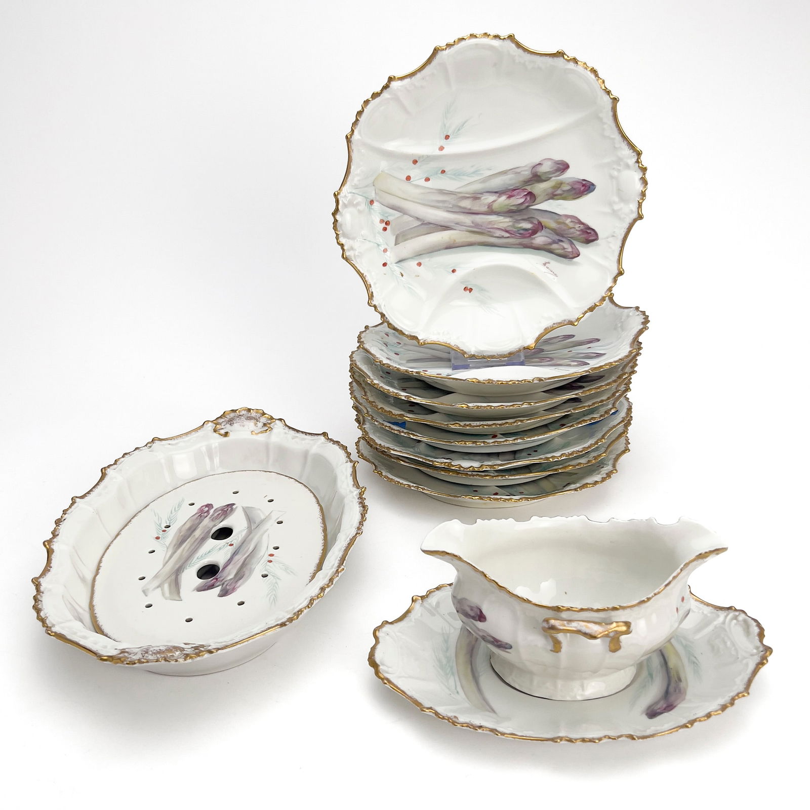 Limoges Porcelain Asparagus Service, Set of 12: Lot 226 Limoges Porcelain Asparagus Service, Set of 12 porcelain A Limoges, France porcelain asparagus service featuring hand-painted asparagus stalks and a gilt scalloped rim by Lewis,Strauss, &