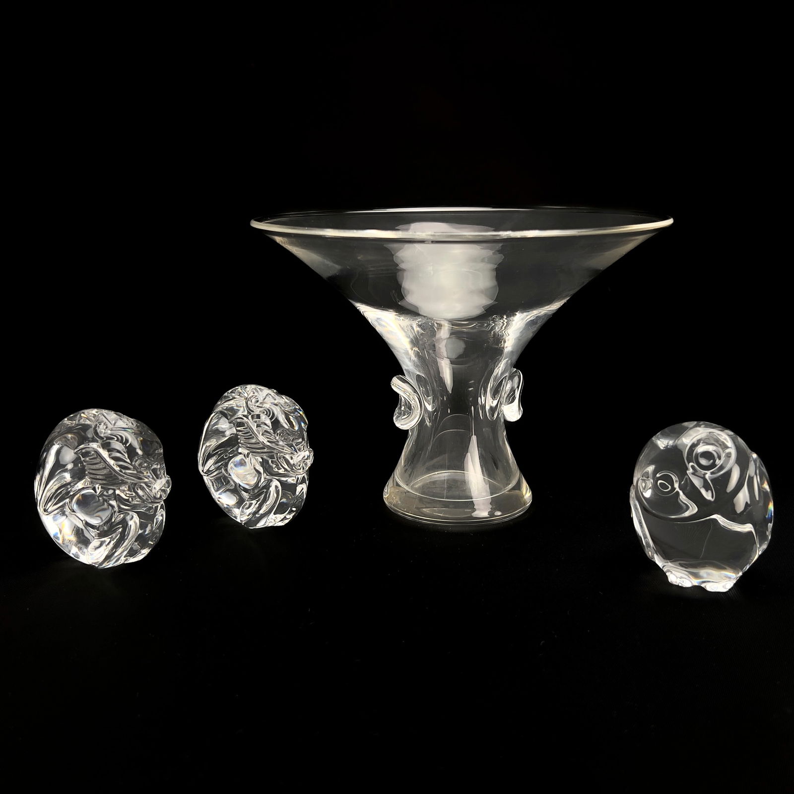 Steuben Glass - Bouquet Vase and Hand Coolers: Lot 240 Steuben Glass American (20th Century) Bouquet Vase and Hand Coolers crystal Steuben glass group, comprising of a clear glass bouquet vase, and three crystal hand coolers, two dragons and one o