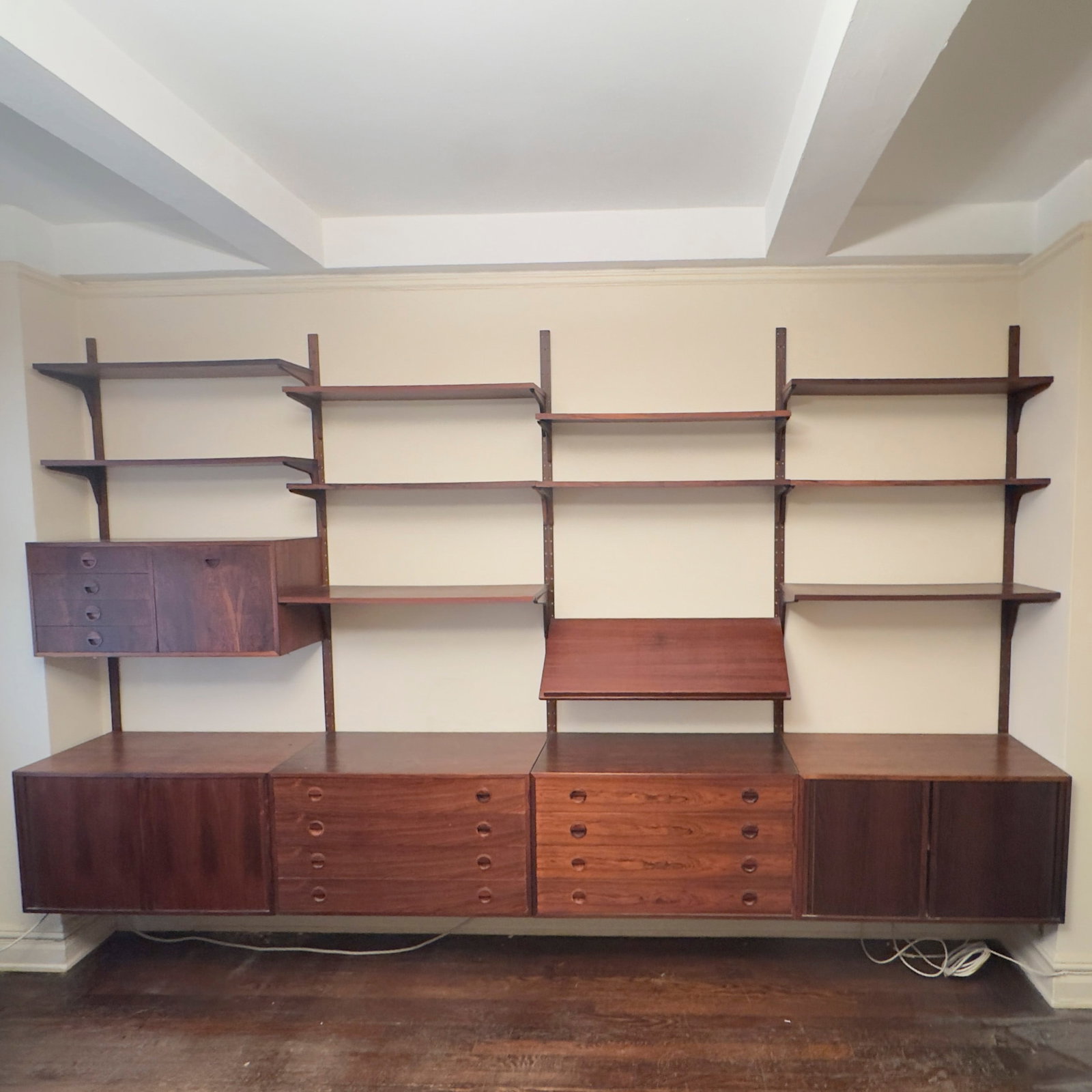 Hansen and Guldborg - 4 Bay Modern Modular Shelving System: Lot 8 Hansen and Guldborg Danish manufacturer (20th Century) 4 Bay Modern Modular Shelving System (circa 1965) Rosewood (palisander) veneer, solid wood pulls, brass and metal suspension hardware, and 
