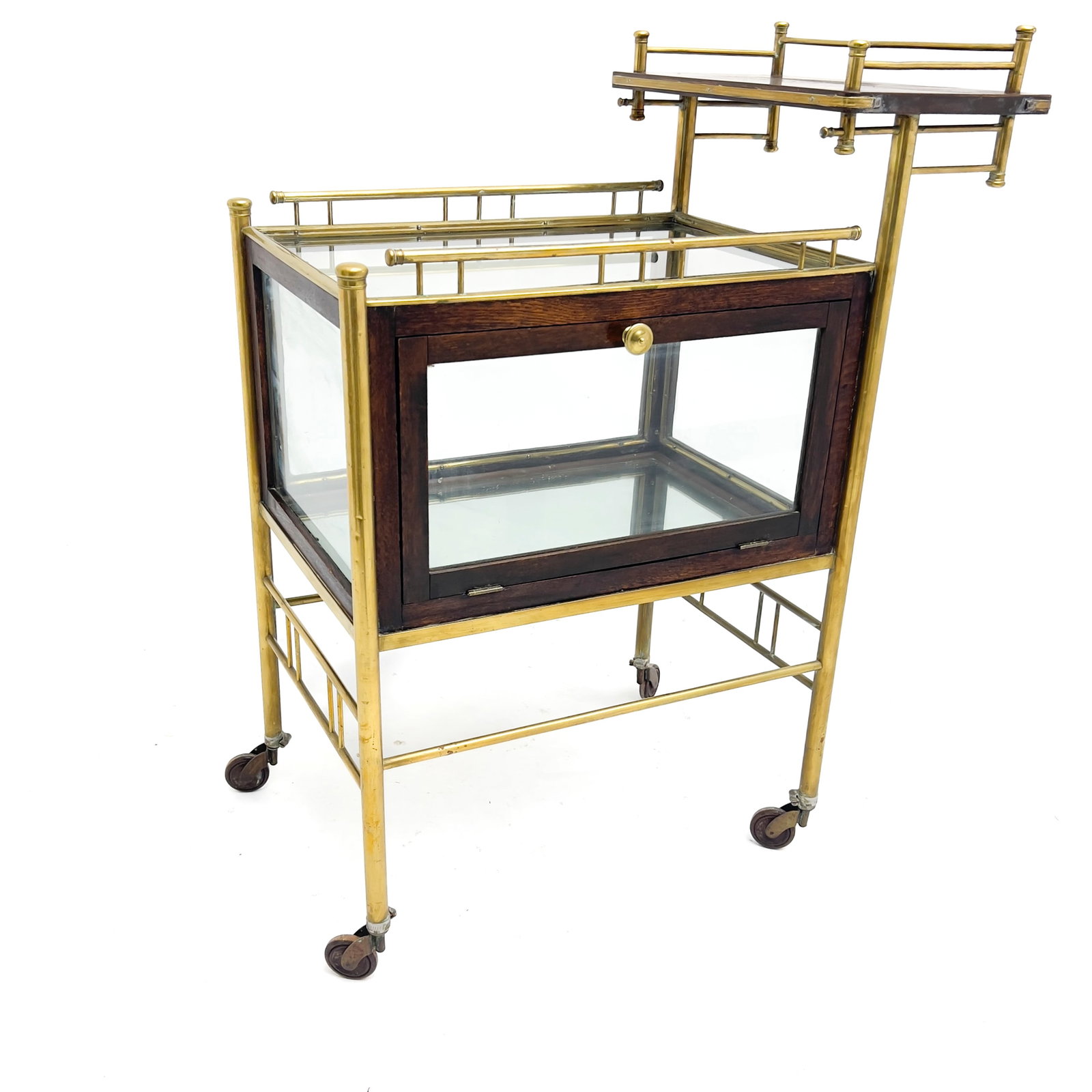 Ernst Rockhausen (attributed) - An Art Deco Pastry Cart or Bar Trolley: Lot 9 Ernst Rockhausen (attributed) German Manufacturer (1866-1972) An Art Deco Pastry Cart or Bar Trolley (20th Century) Brass, oak wood, glass 40 x 30 1/2 x 17 1/2 inches Description: An early 20th
