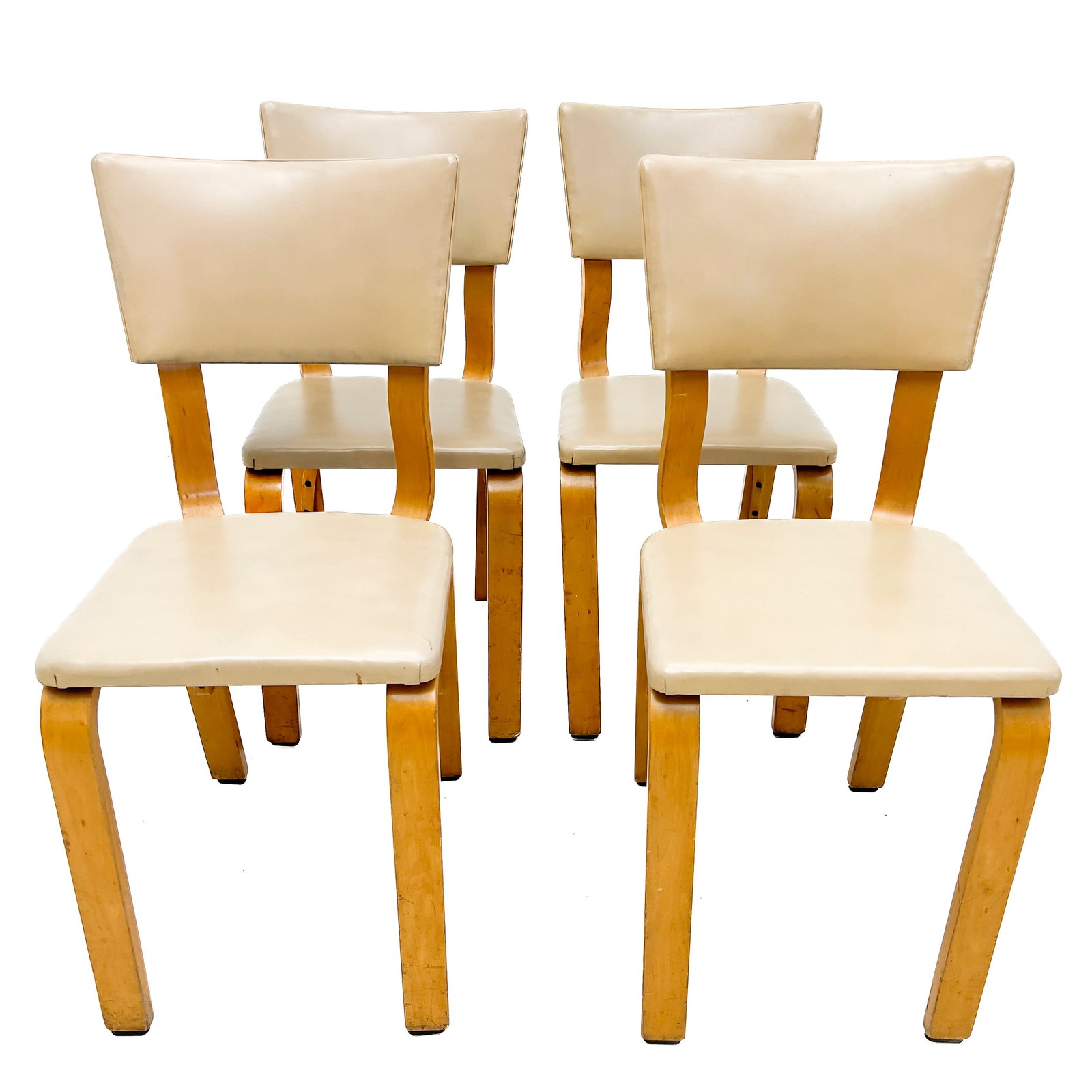 Thonet - A Suite of Four Mid-Century Modern Bentwood Dining Chairs: Lot 30 Thonet Austrian Manufacturer (Founded 1853) A Suite of Four Mid-Century Modern Bentwood Dining Chairs (20th Century) Maple bentwood, laminated plywood, vinyl upholstery, steel hardware each: 33