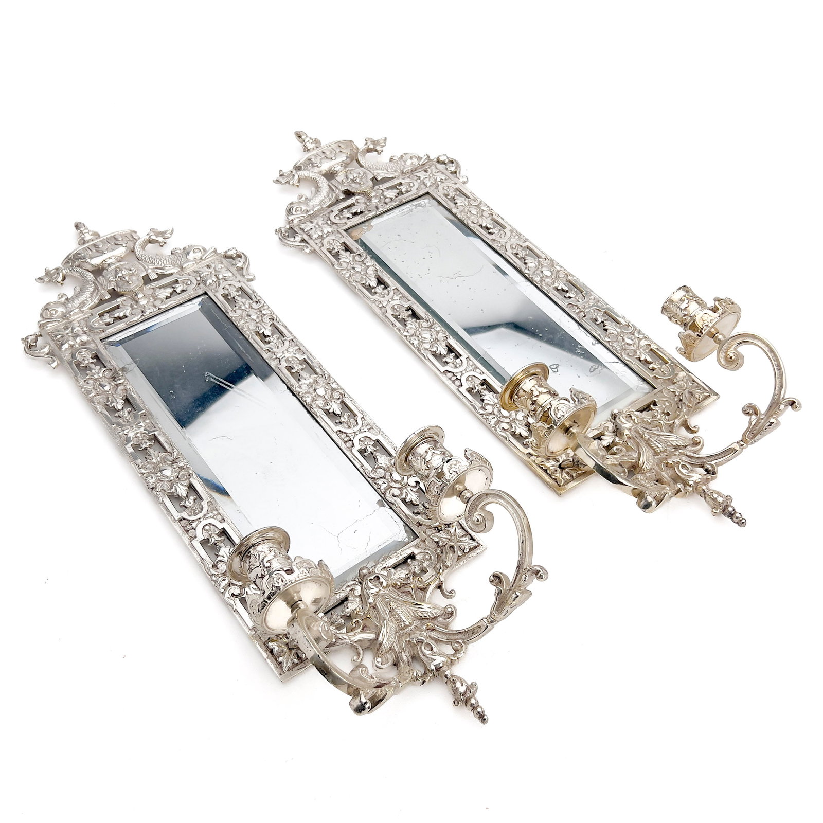 A Pair of Continental Silver-Plated Girandole Wall Sconces: Lot 105 A Pair of Continental Silver-Plated Girandole Wall Sconces Silver-plated cast metal, mirrored glass plates, and felt backing each: 24 x 8 1/2 x 4 1/4 inches Description: A pair of 20th-century