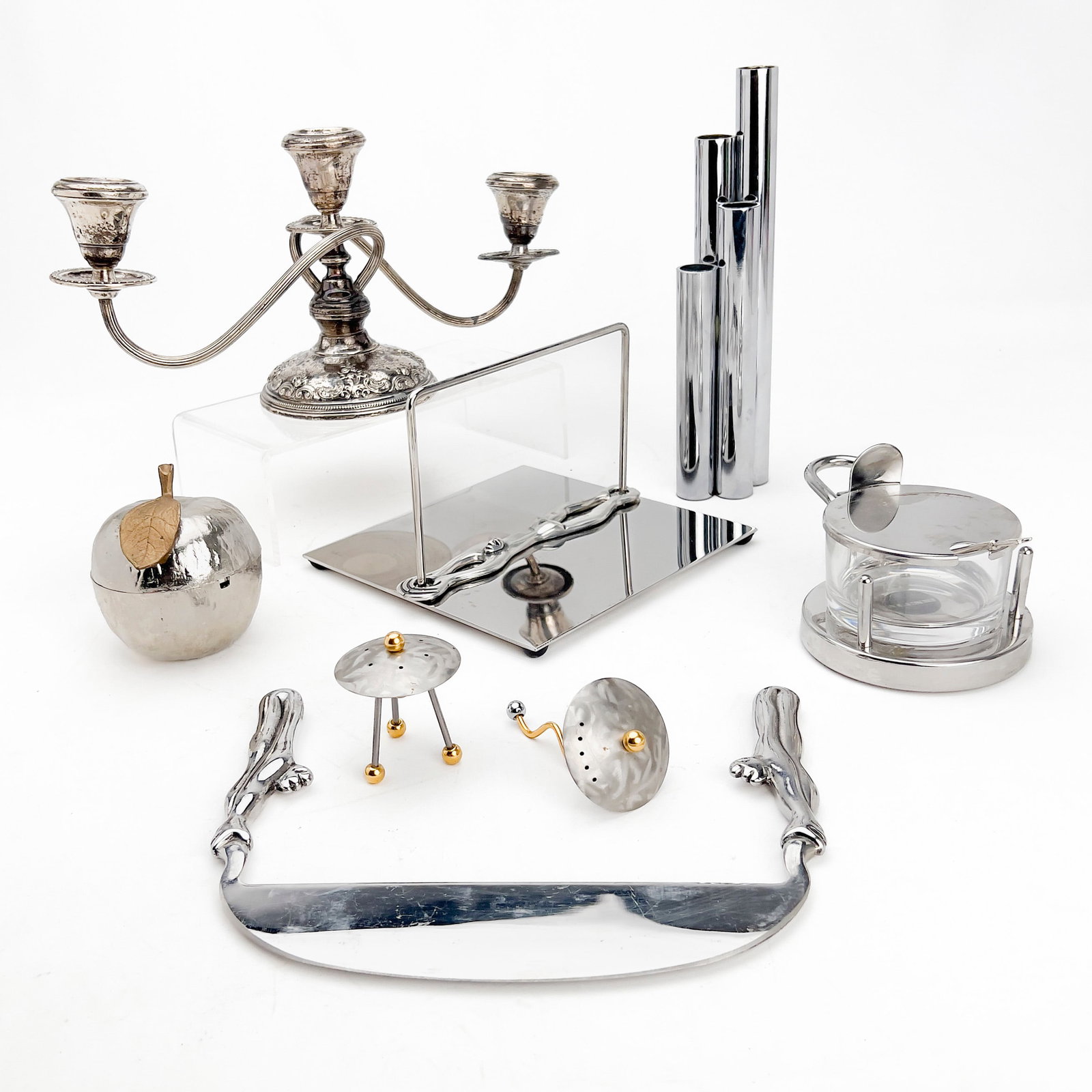 Designer Metal Tabletop Group: Lot 131 Designer Metal Tabletop Group Nickelplate, bronze, enamel, stainless steel, gold-plating, glass, sterling silver, silver-plate Tallest: 10 1/2\” x 2 3/4\” x 2\” inches stampe
