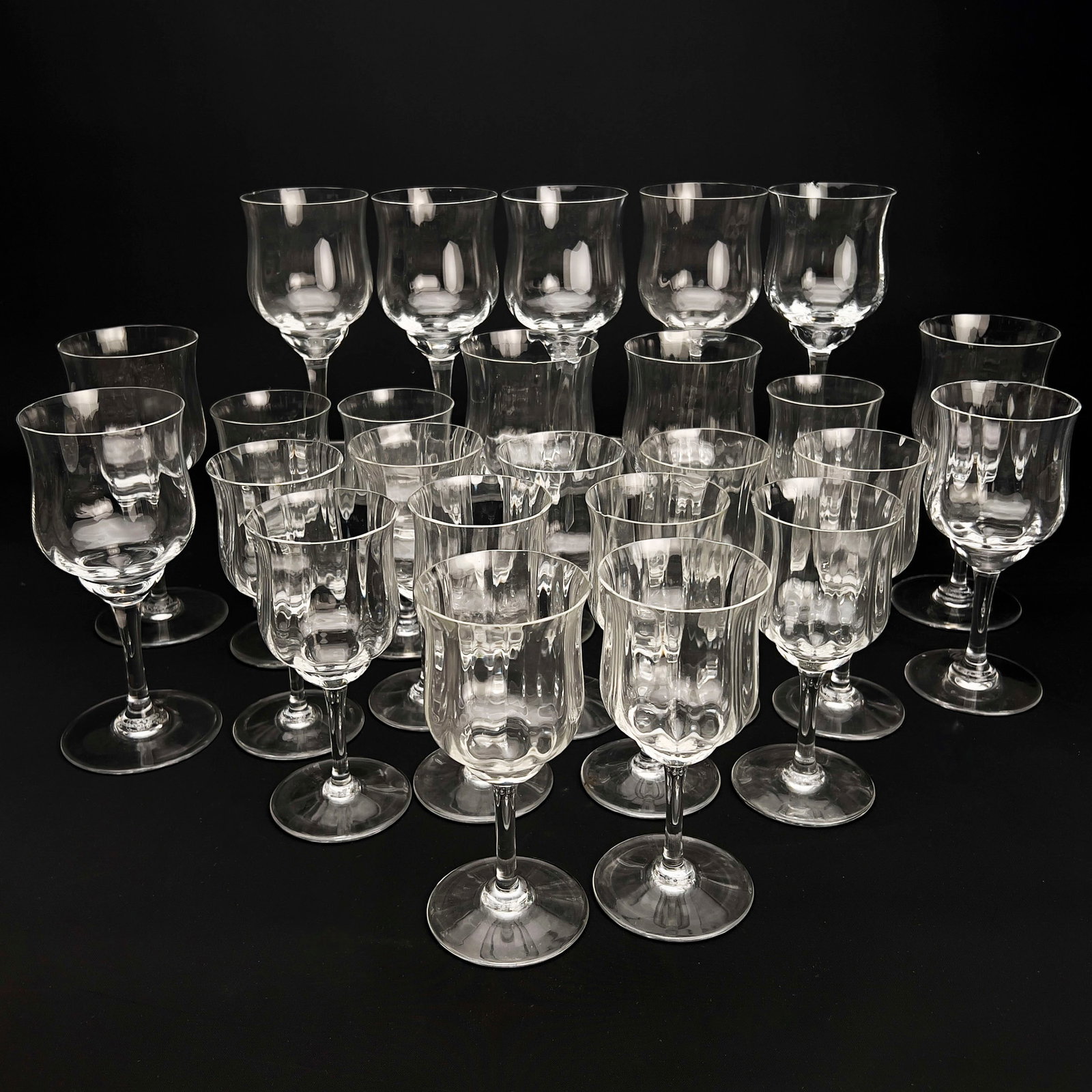 Baccarat - A 25 Piece Collection of Baccarat Capri Optic Stemware: Lot 133 Baccarat French Manufacturer (est. 1764) A 25 Piece Collection of Baccarat Capri Optic Stemware Hand-blown optic lead crystal height (water goblet): 7 1/8 inches height (wine glass): 6 inches 