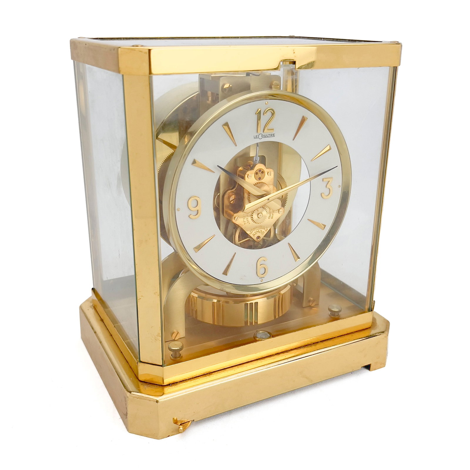Jaeger-LeCoultre - Atmos Clock: Lot 152 Jaeger-LeCoultre Swiss Manufacturer (founded 1833) Atmos Clock 9 x 8 1/4 x 6 1/4 inches maraked to underside, top, clockface, numbered 261156 Description: Rectangular gilt case with canted co