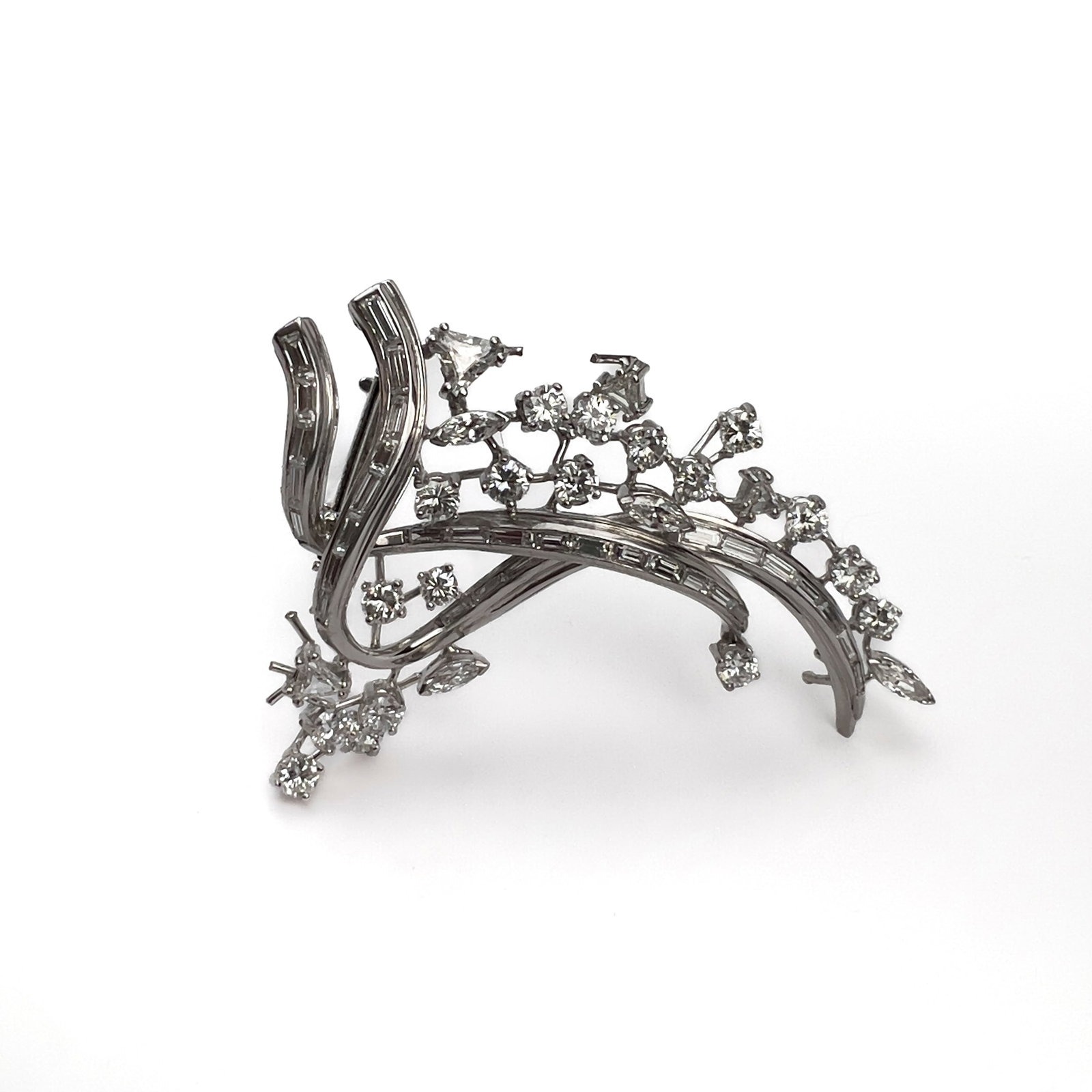 Platinum and Diamond Brooch: Lot 93 Platinum and Diamond Brooch (circa 1950) Platinum, diamond 2 1/4 x 1 1/2 inches Description: An abstract platinum and diamond stylized cluster spray brooch weighing approximately 17.5 grams